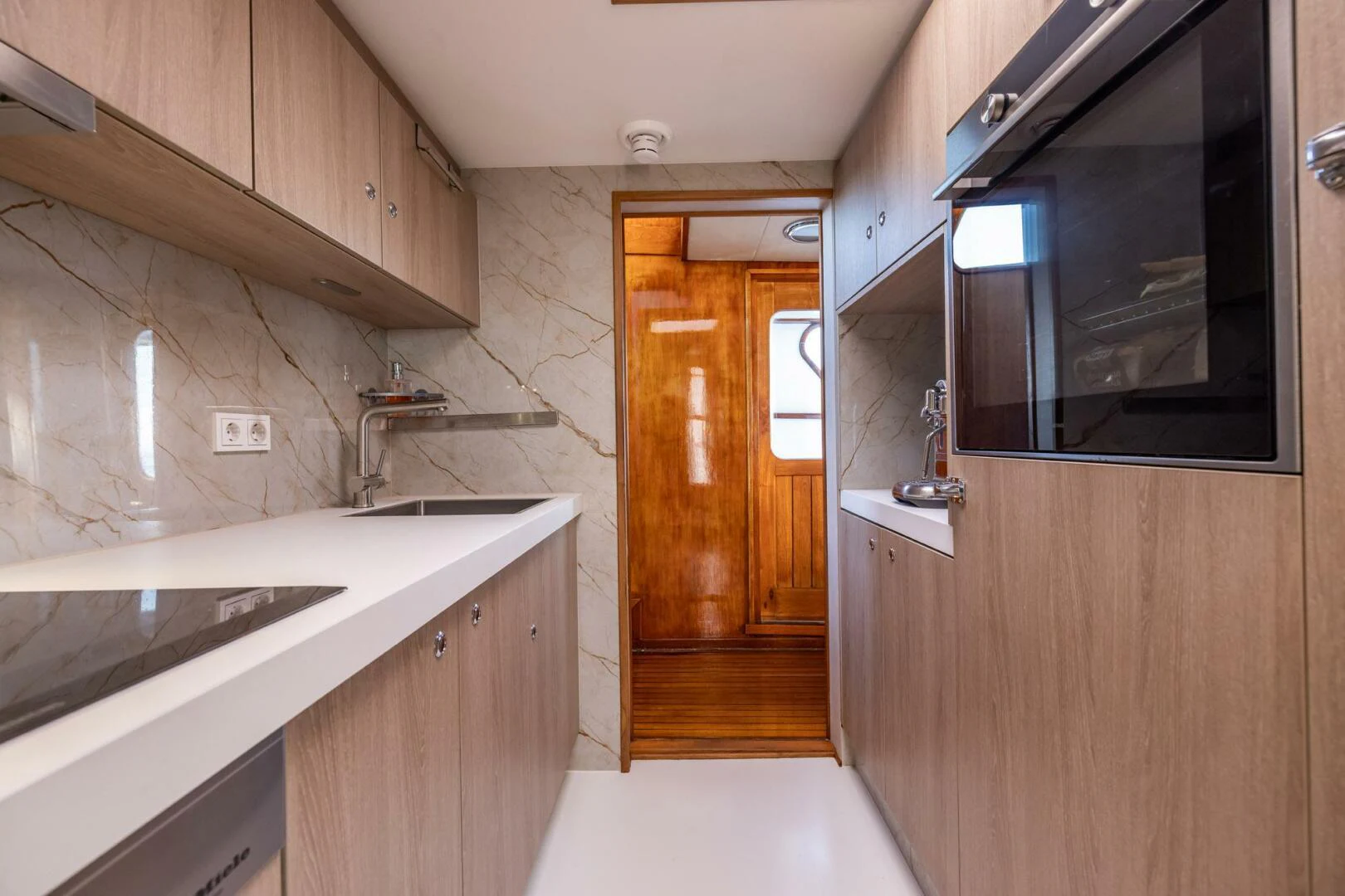 a kitchen with wooden cabinets aboard SISSI Yacht for Sale