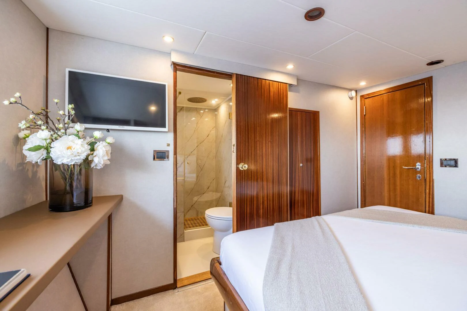 a hotel room with a television and a bed aboard SISSI Yacht for Sale