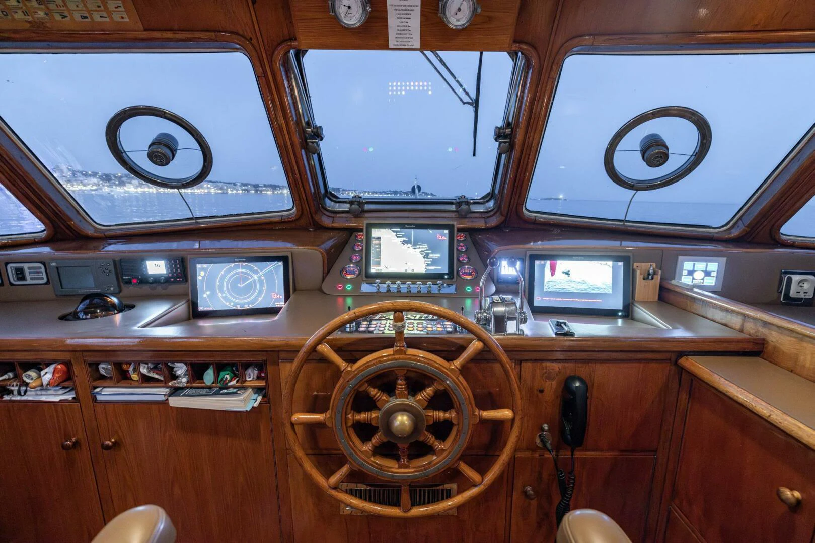 a wooden cabinet with various electronic devices aboard SISSI Yacht for Sale