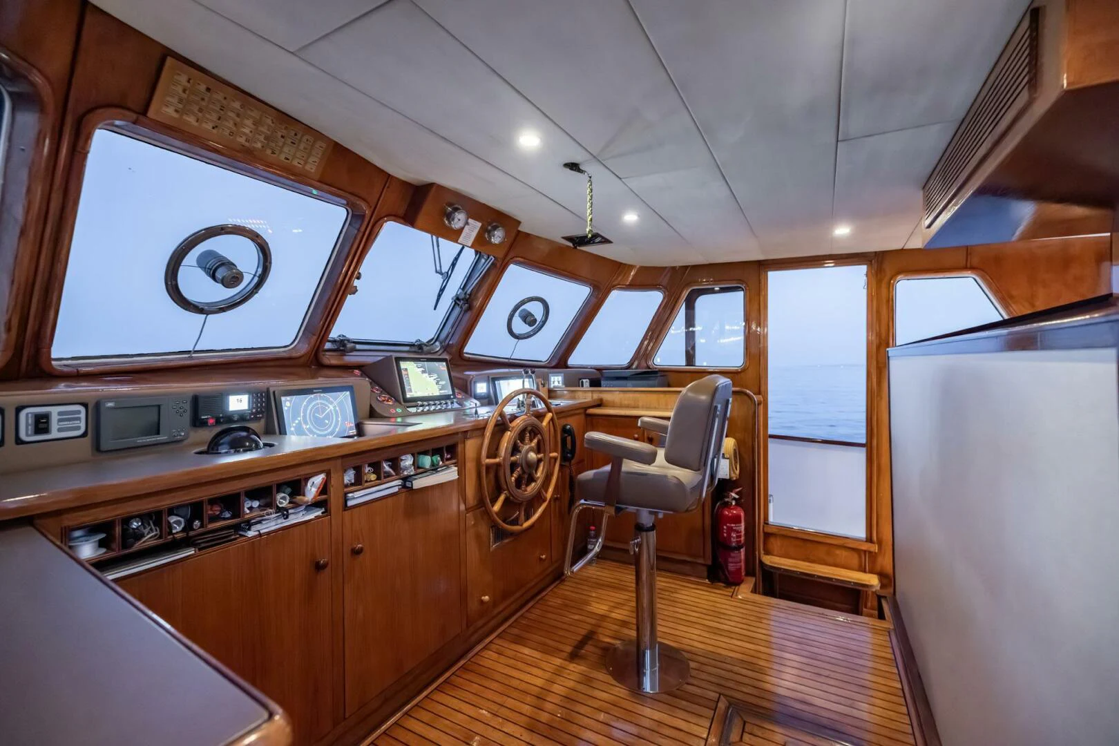 a kitchen with wooden cabinets aboard SISSI Yacht for Sale