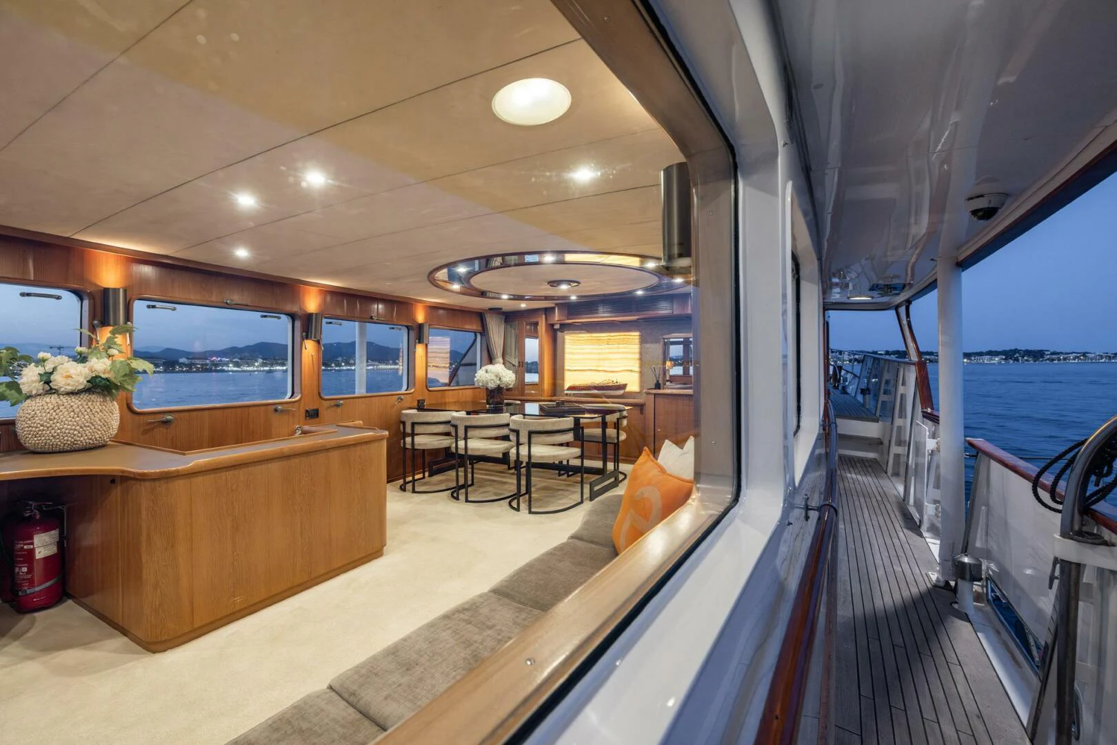 inside of a building with a table and chairs and a large window aboard SISSI Yacht for Sale