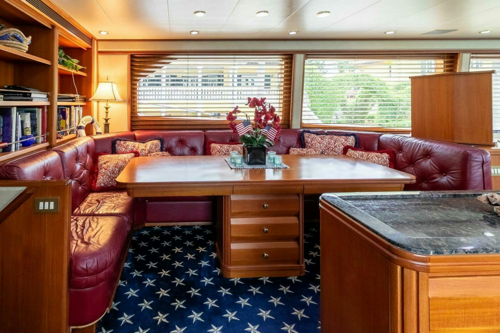 a living room with a table and couches aboard CHAIRMAN  Yacht for Sale