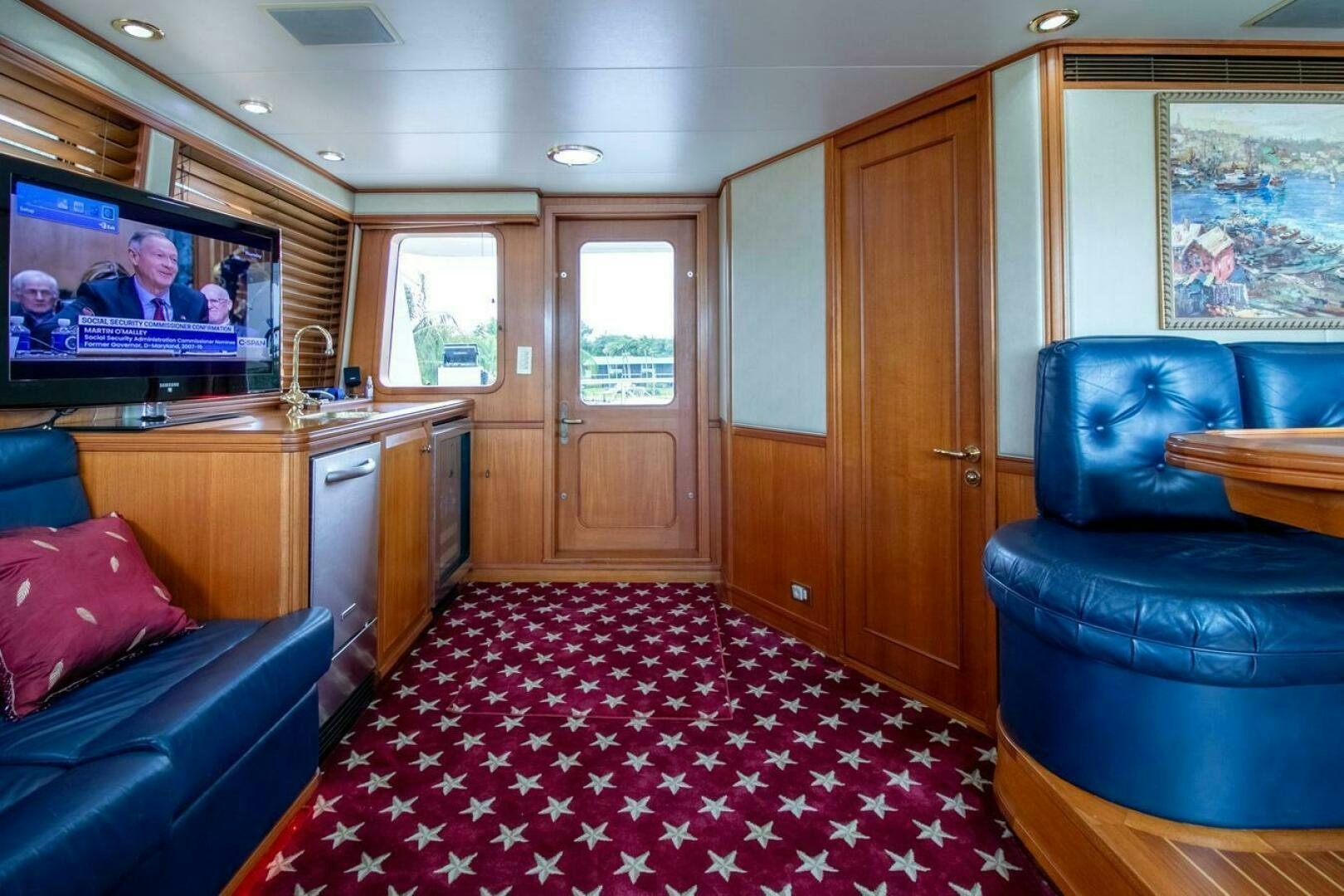 a living room with a tv and couches aboard CHAIRMAN  Yacht for Sale
