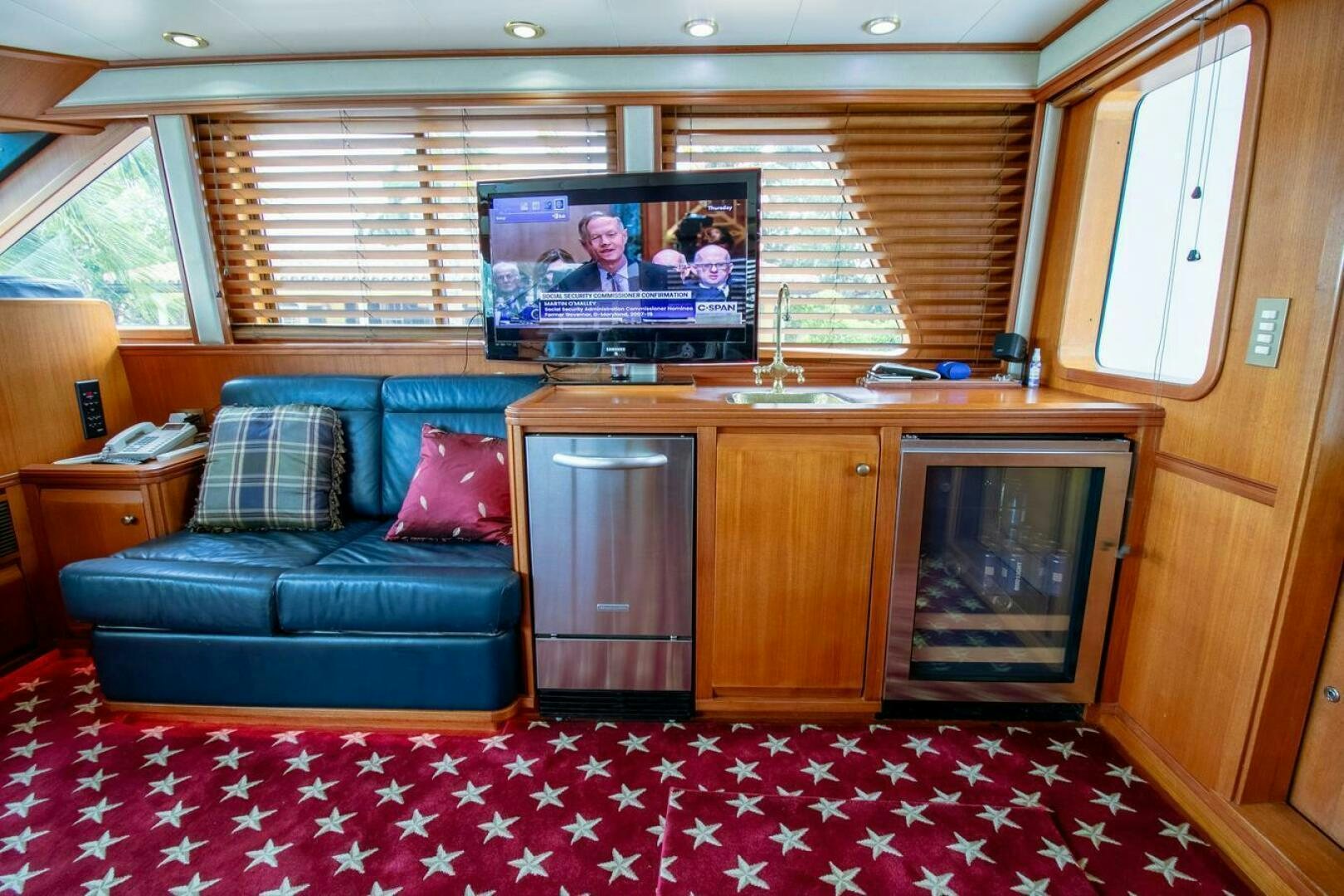 a living room with a couch and tv aboard CHAIRMAN  Yacht for Sale