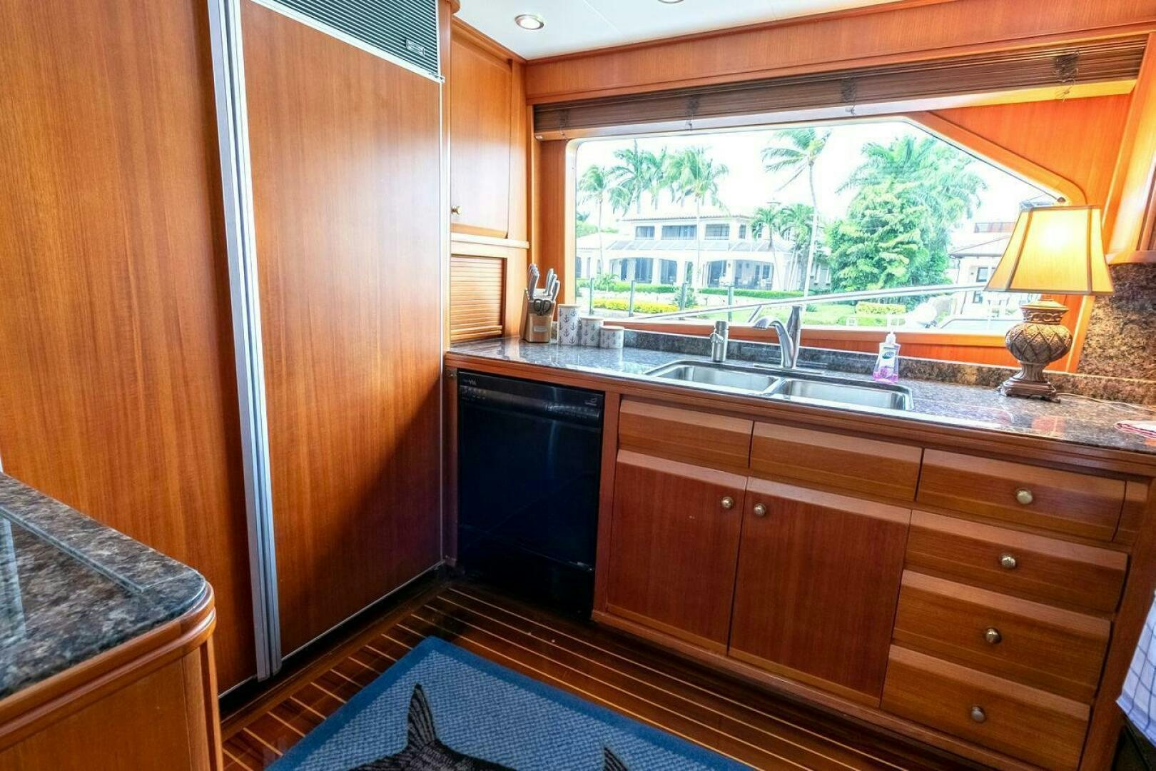 a kitchen with wooden cabinets aboard CHAIRMAN  Yacht for Sale