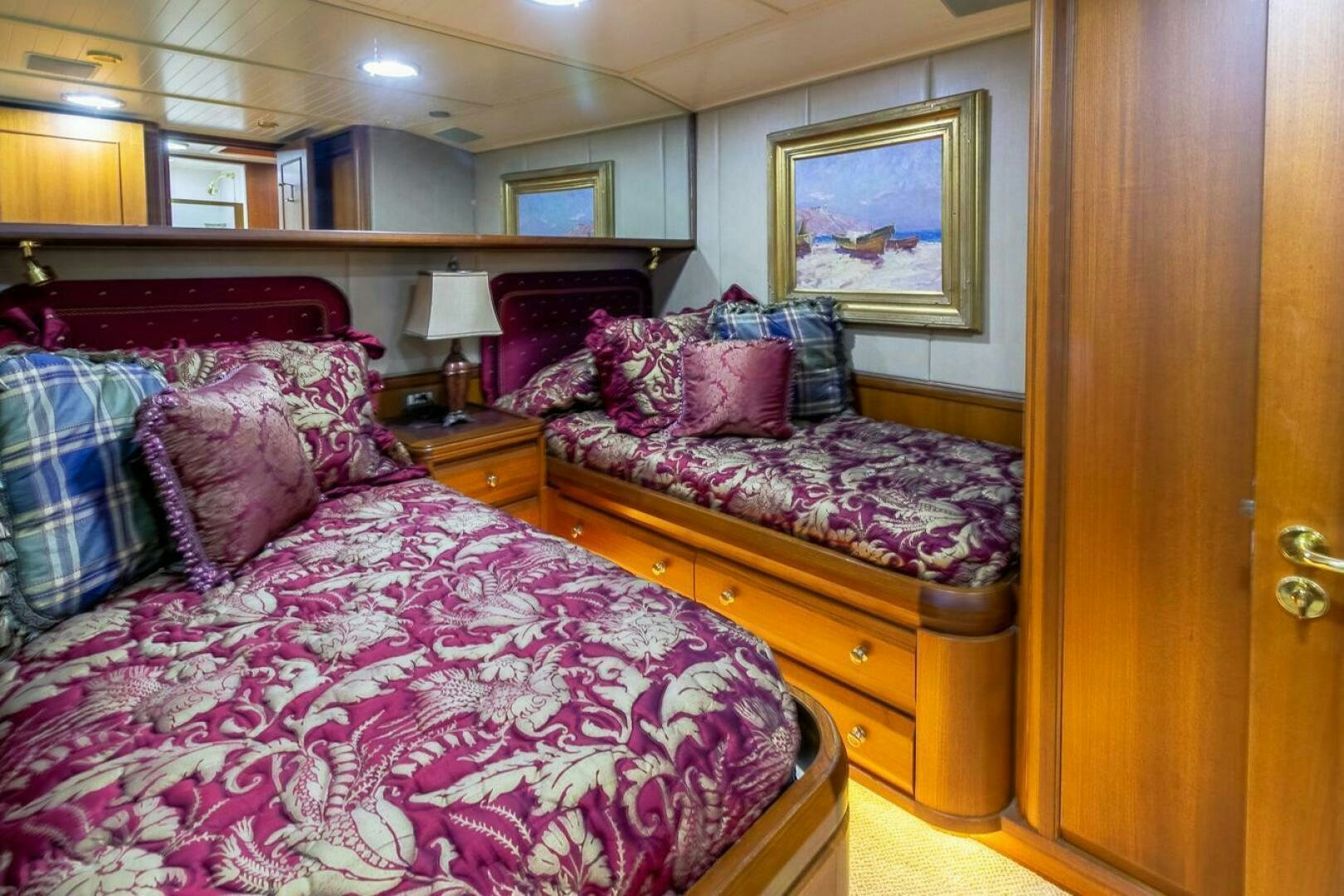 a bedroom with a bed and a dresser aboard CHAIRMAN  Yacht for Sale