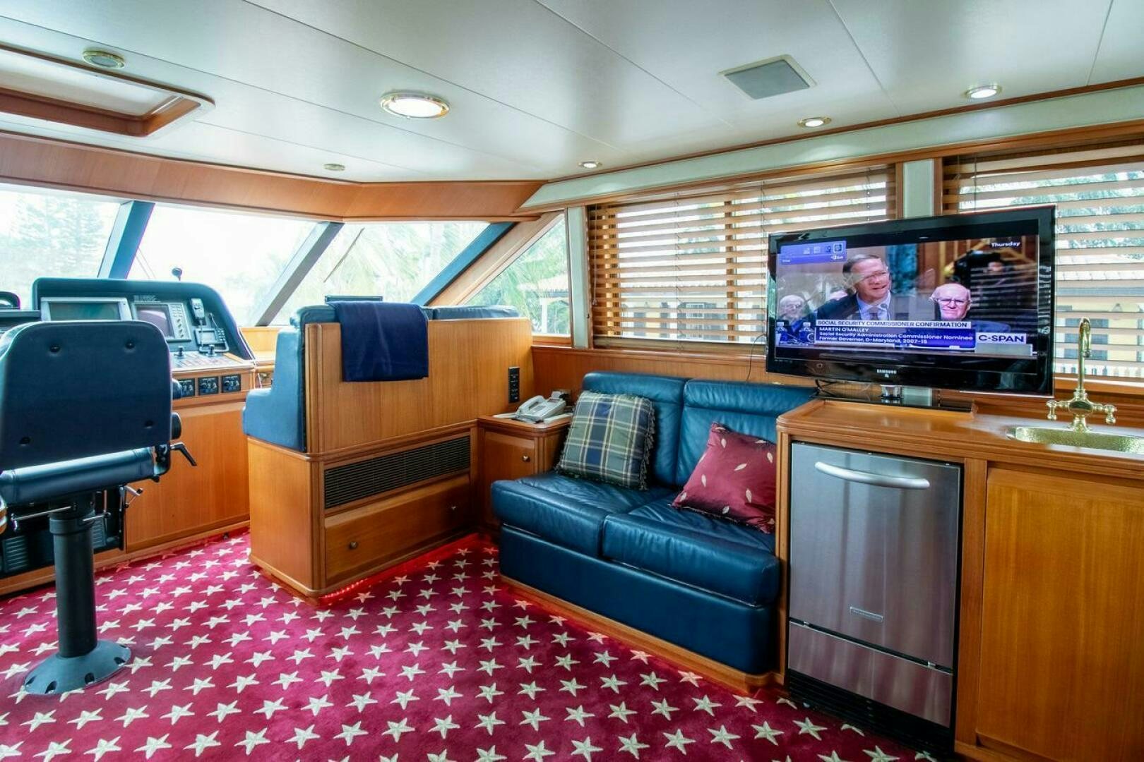 a living room with a couch and tv aboard CHAIRMAN  Yacht for Sale