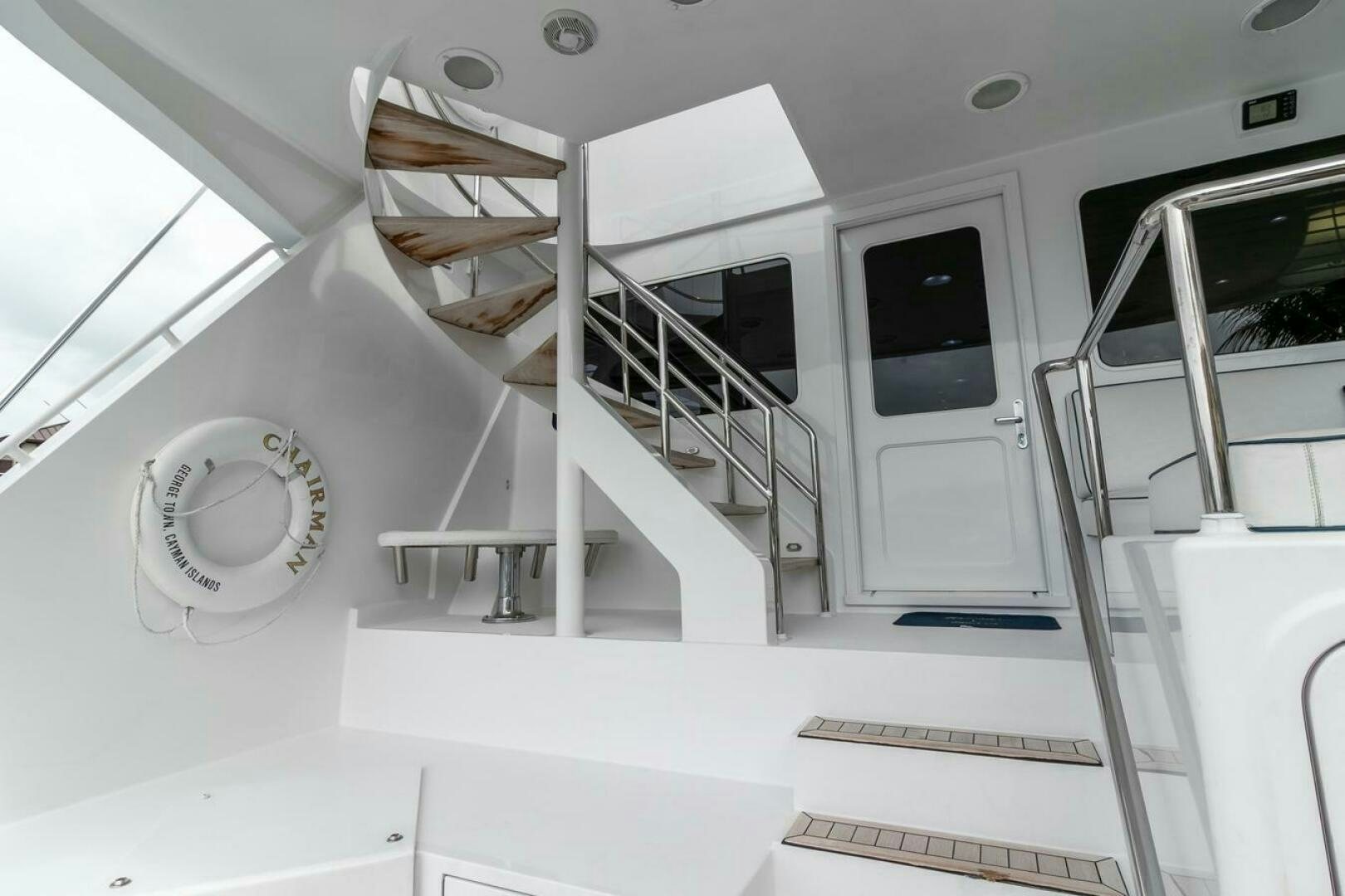 a white room with a staircase and a window aboard CHAIRMAN  Yacht for Sale