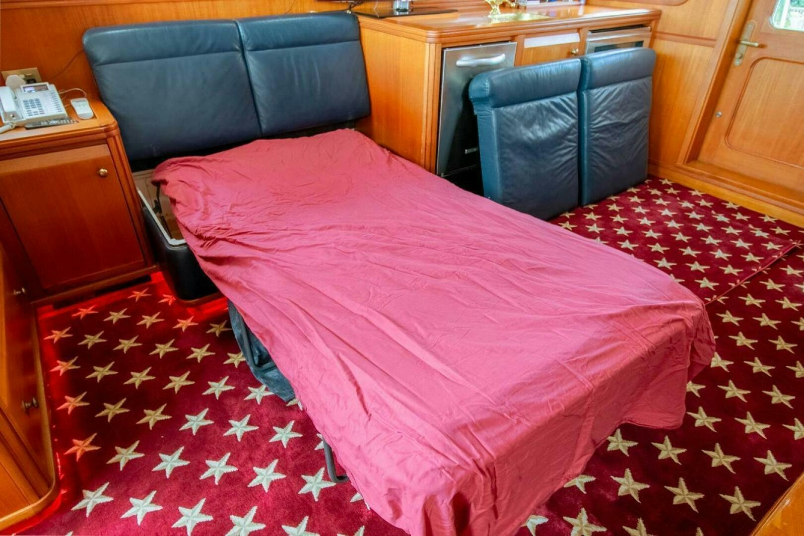 a bed with a pink comforter aboard CHAIRMAN  Yacht for Sale