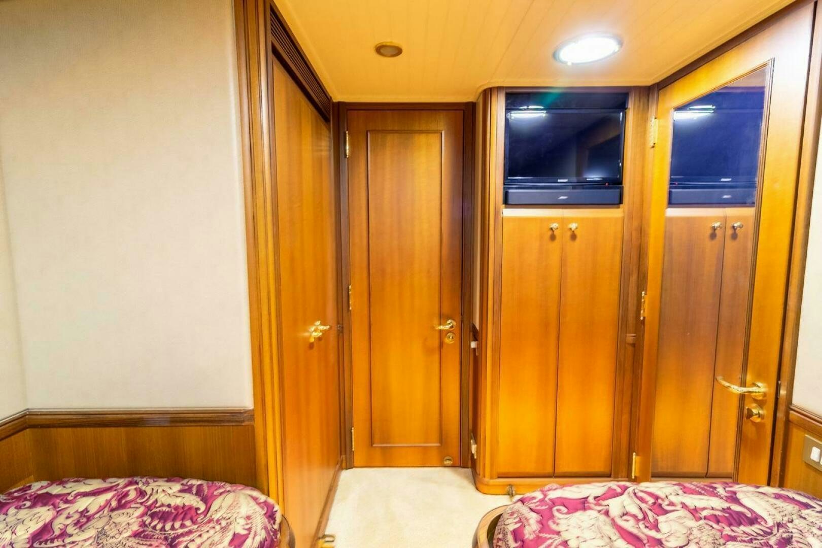 a room with a bed and a closet aboard CHAIRMAN  Yacht for Sale