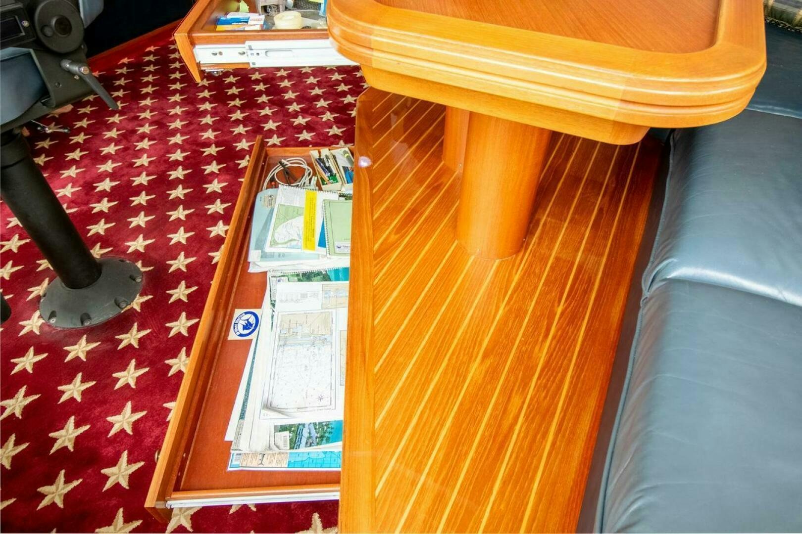a book on a table aboard CHAIRMAN  Yacht for Sale