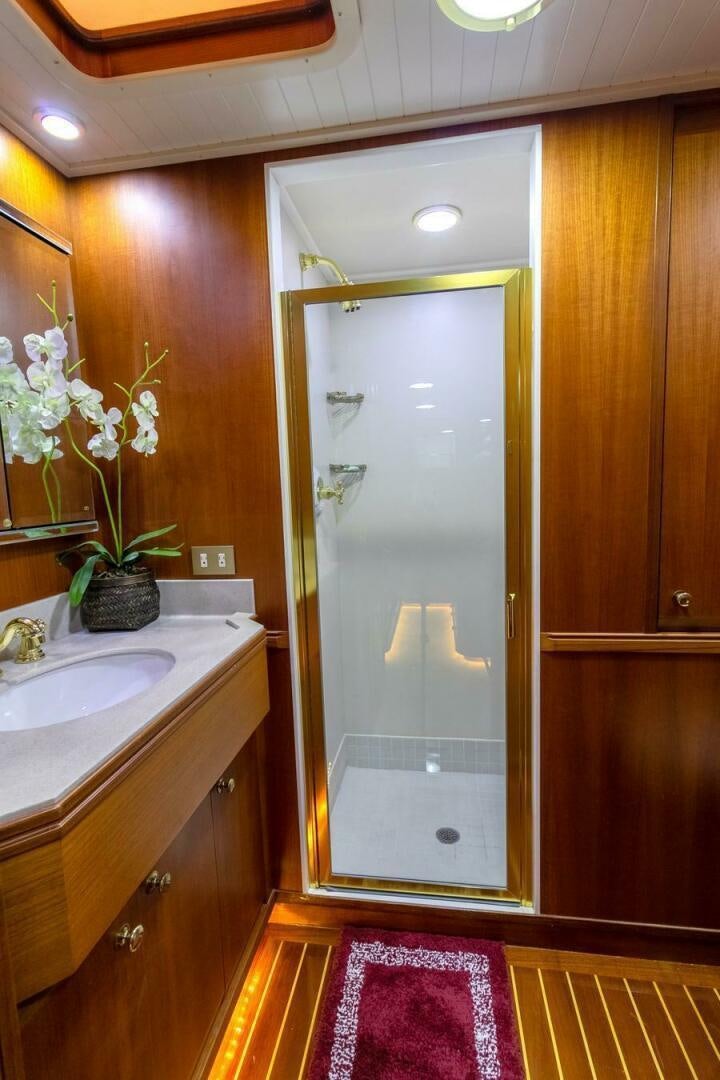 a bathroom with a sink and a mirror aboard CHAIRMAN  Yacht for Sale