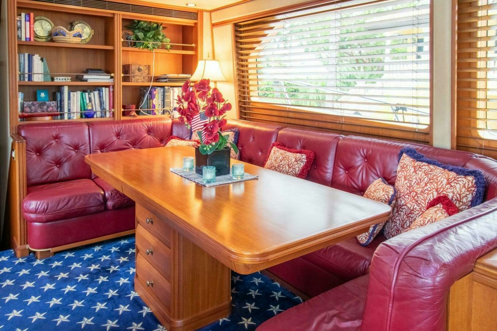 a living room with a table and couches aboard CHAIRMAN  Yacht for Sale