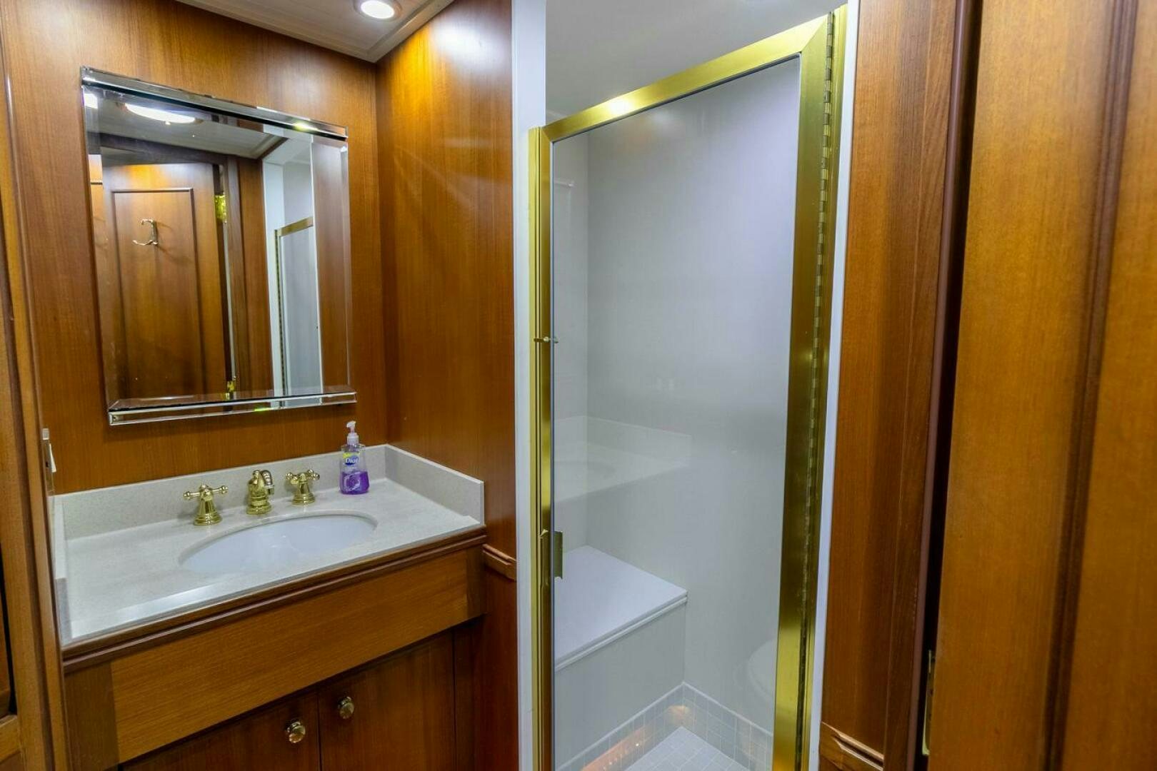 a bathroom with a sink and a mirror aboard CHAIRMAN  Yacht for Sale