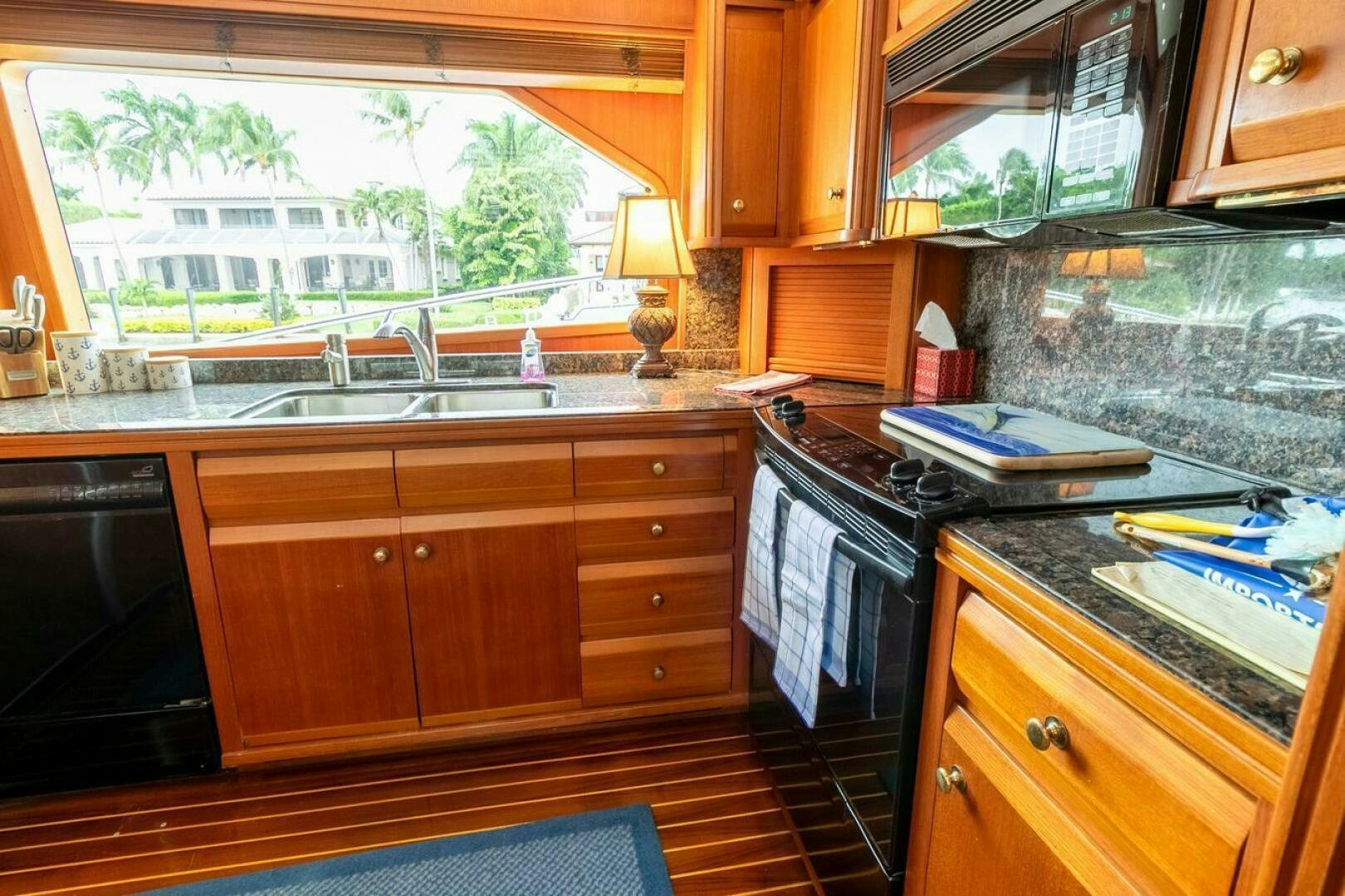 a kitchen with wooden cabinets aboard CHAIRMAN  Yacht for Sale