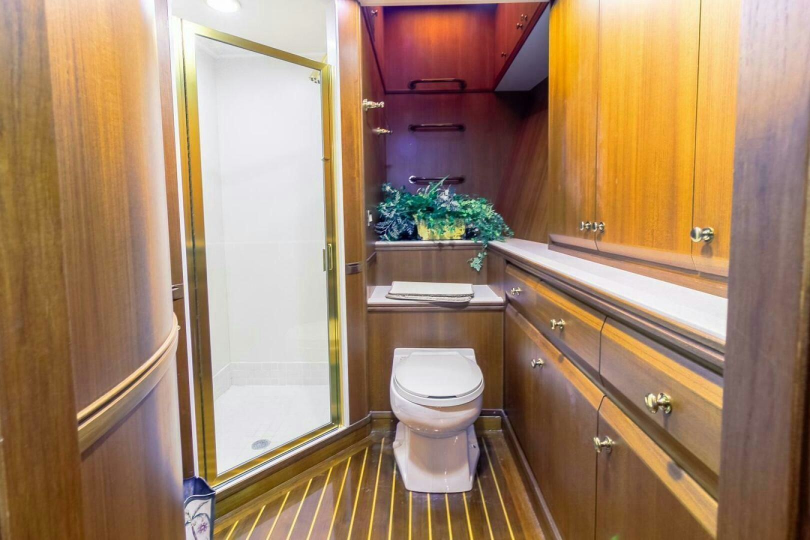 a bathroom with a toilet and cabinets aboard CHAIRMAN  Yacht for Sale