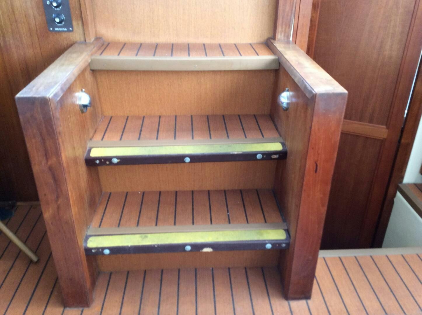 a wooden bench with a wooden frame aboard TREES HOUSE Yacht for Sale