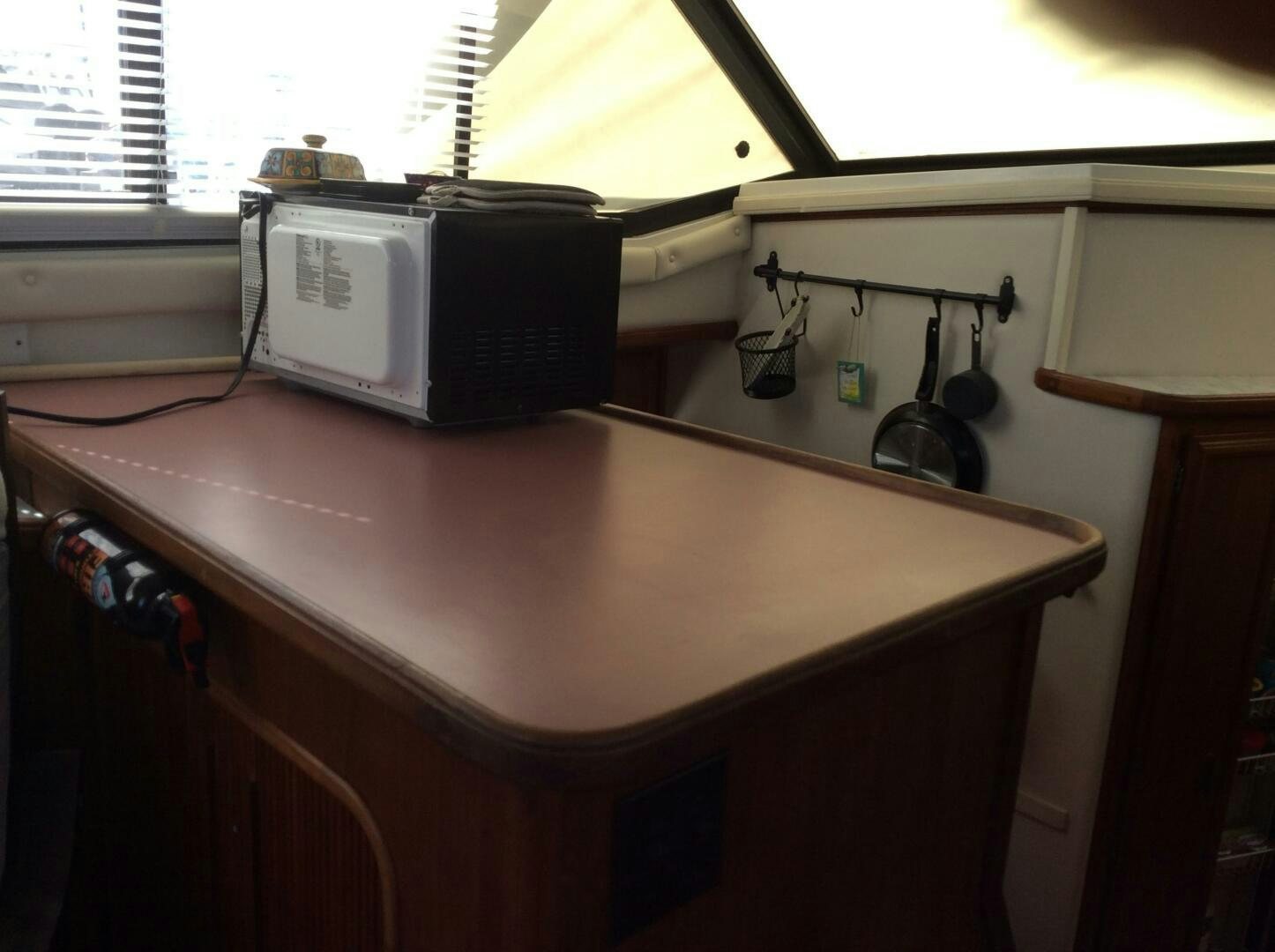 a kitchen with a microwave and a stove aboard TREES HOUSE Yacht for Sale