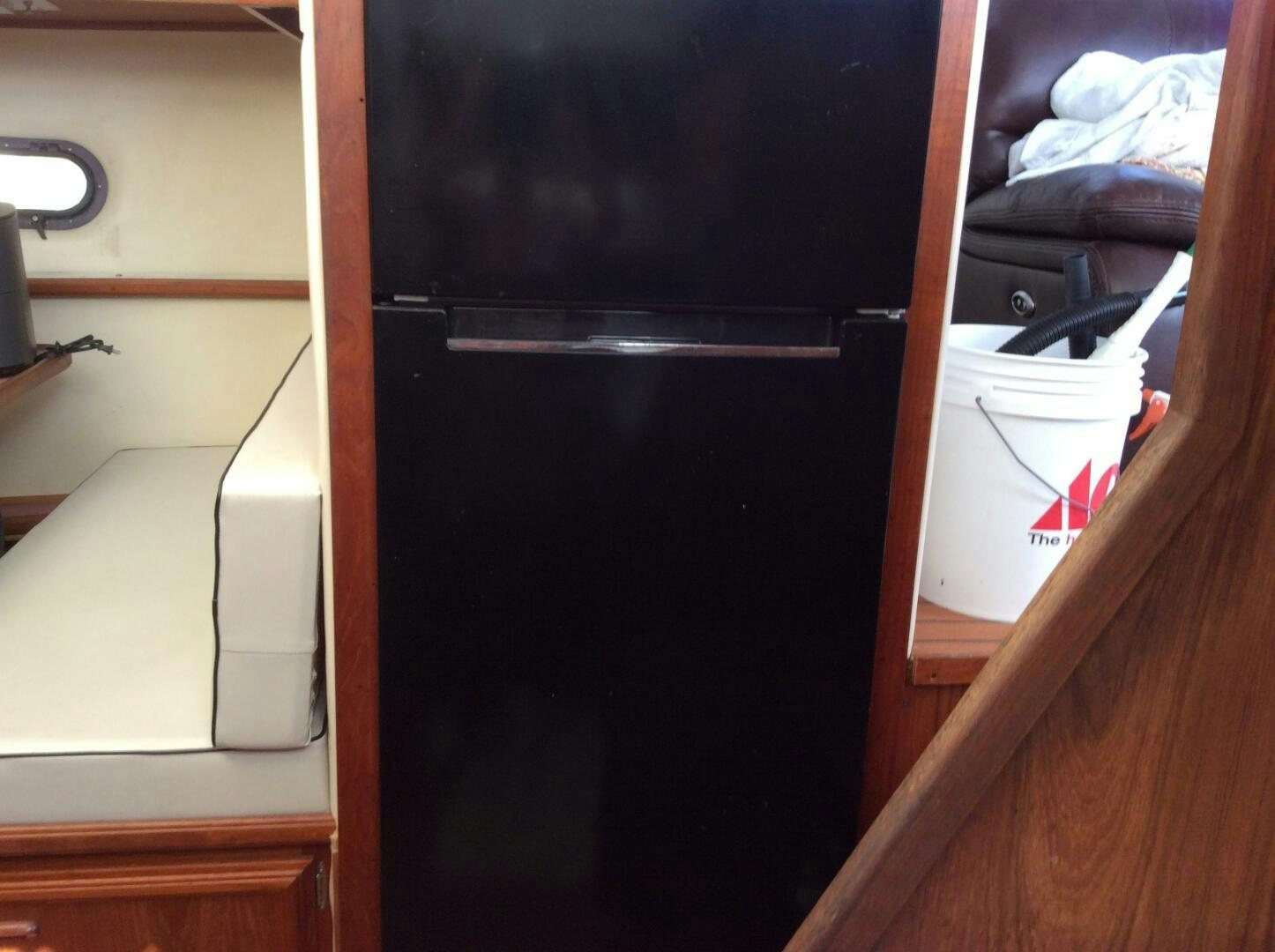 a black refrigerator in a kitchen aboard TREES HOUSE Yacht for Sale