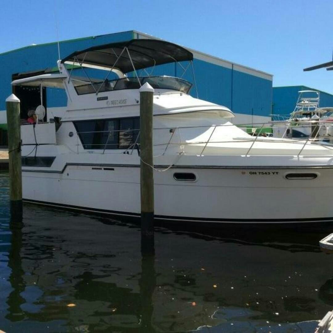 a white boat in a harbor aboard TREES HOUSE Yacht for Sale