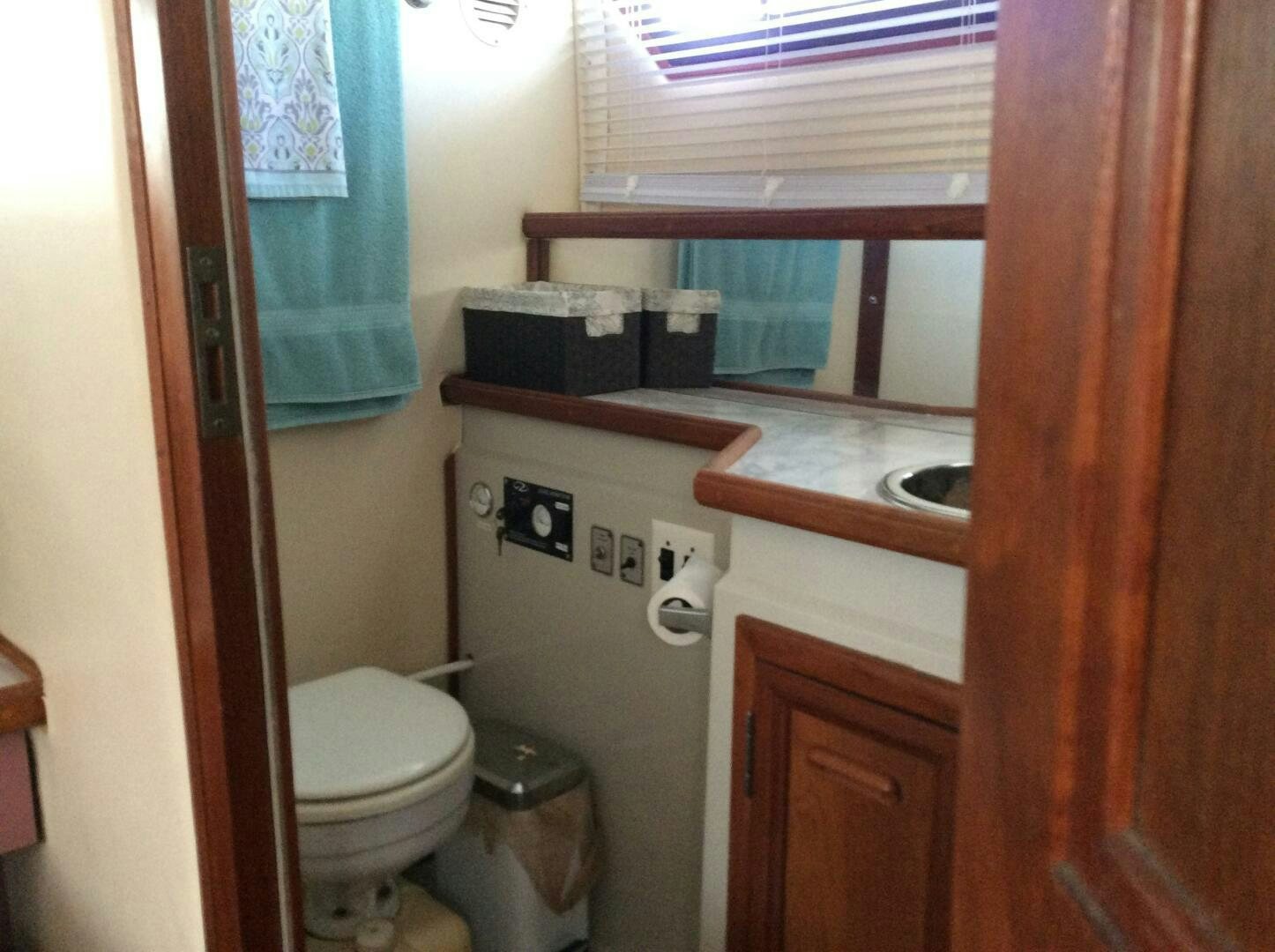 a bathroom with a toilet and sink aboard TREES HOUSE Yacht for Sale