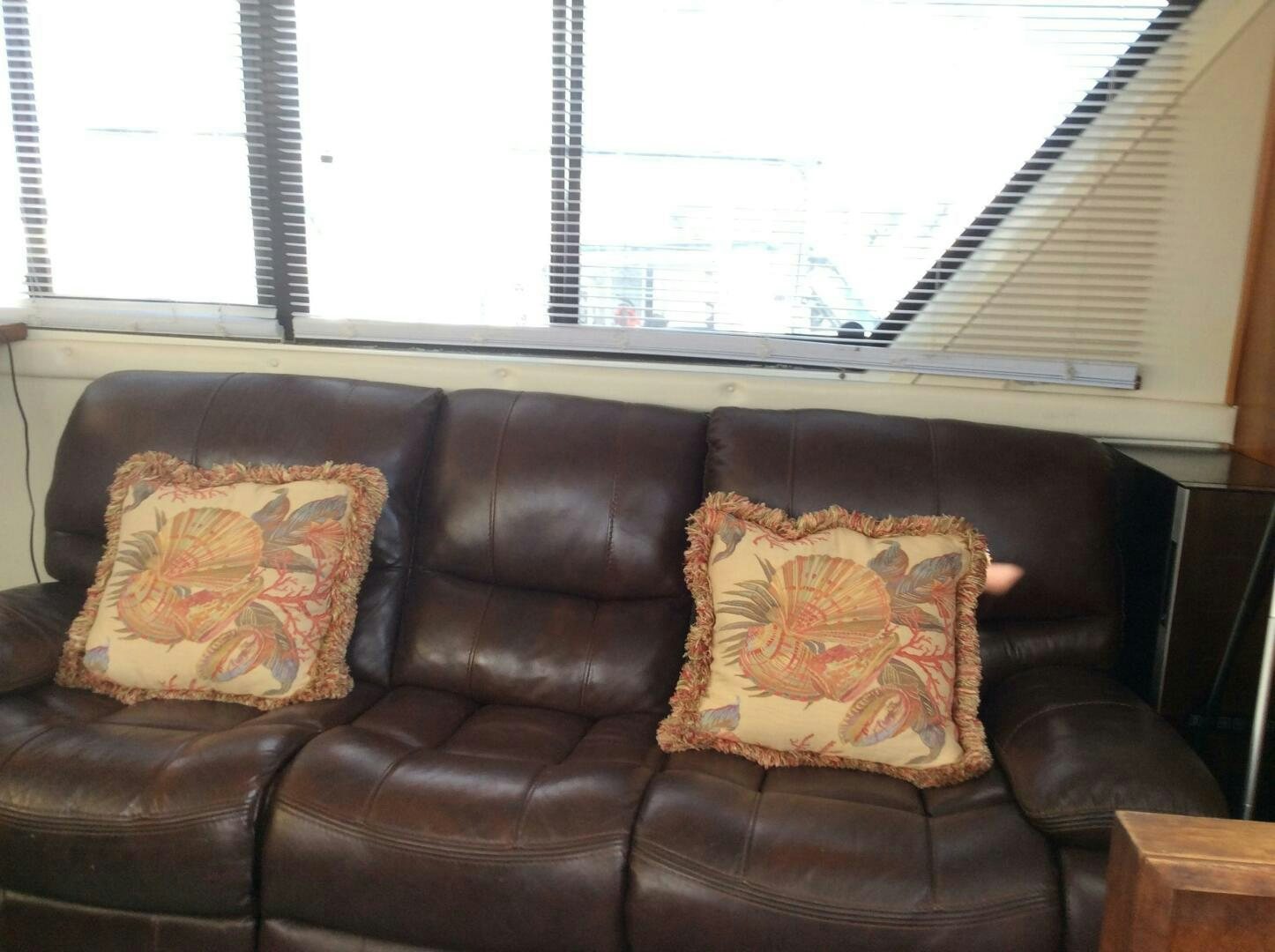 a leather couch in a room aboard TREES HOUSE Yacht for Sale