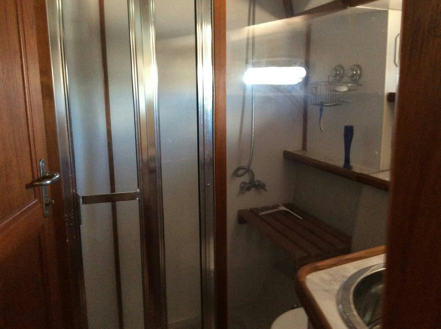 a bathroom with a shower and sink aboard TREES HOUSE Yacht for Sale