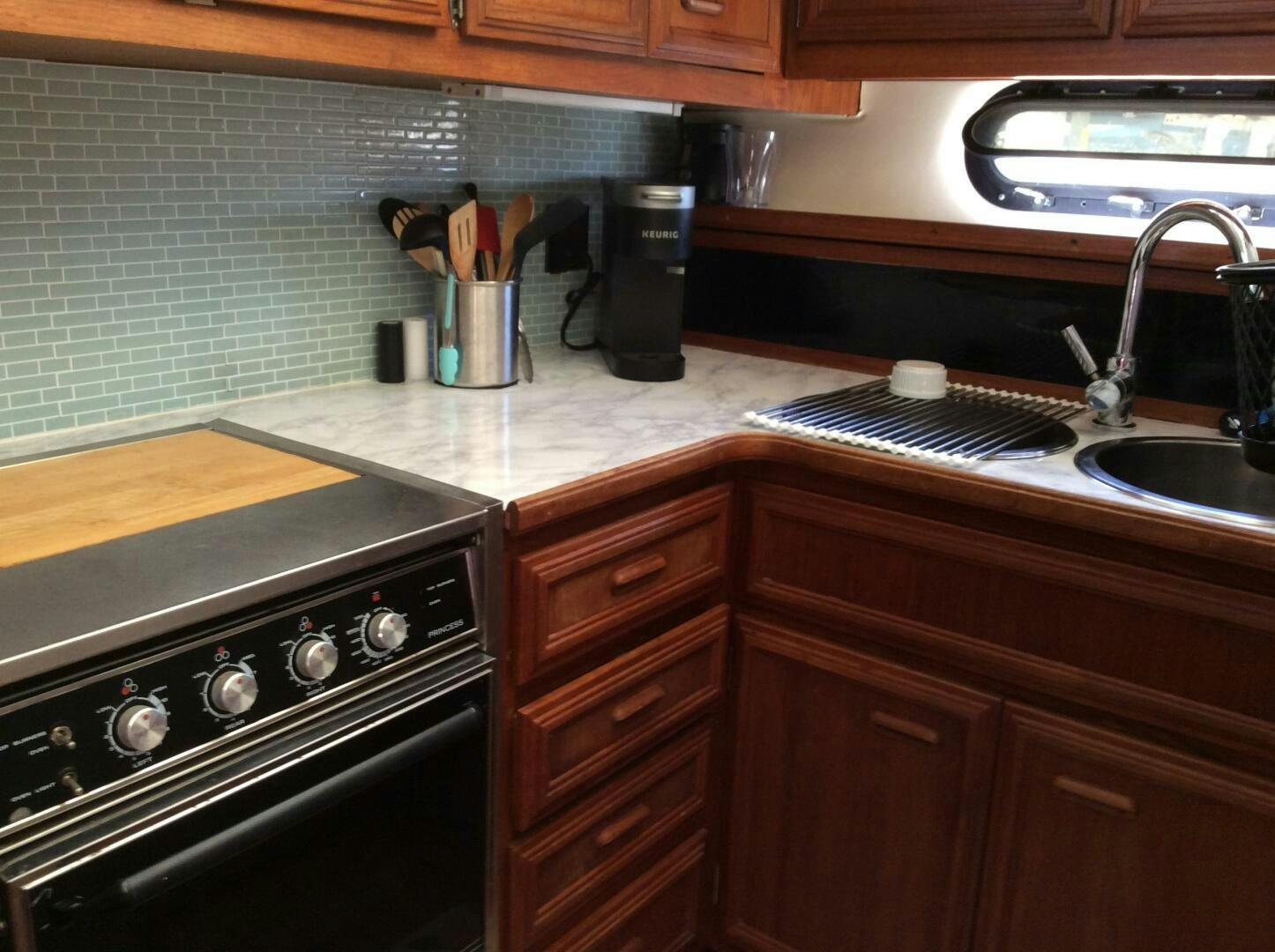 a kitchen with a sink and a stove aboard TREES HOUSE Yacht for Sale