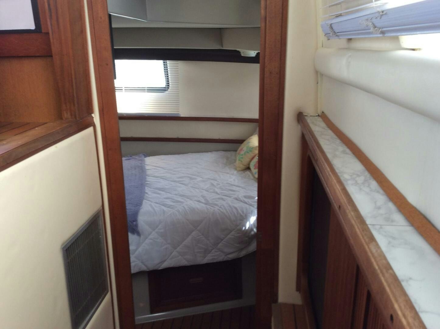 a room with a bed and a window aboard TREES HOUSE Yacht for Sale