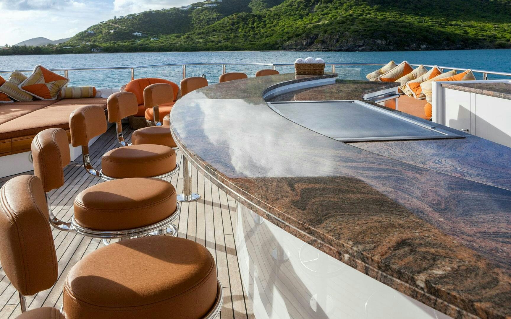 a deck with chairs and a table on it aboard PERLE BLEUE Yacht for Sale