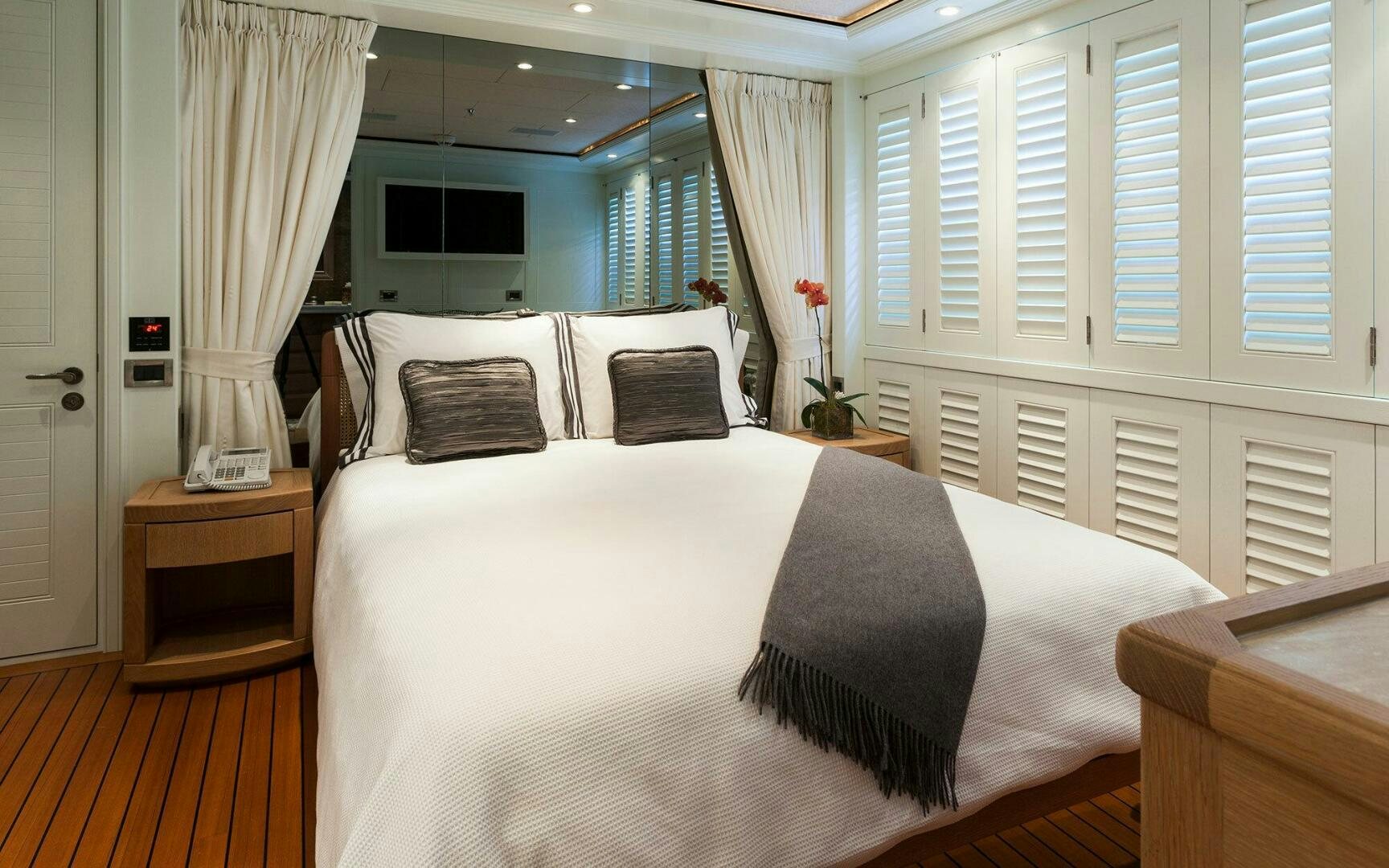 a bed with white sheets aboard PERLE BLEUE Yacht for Sale