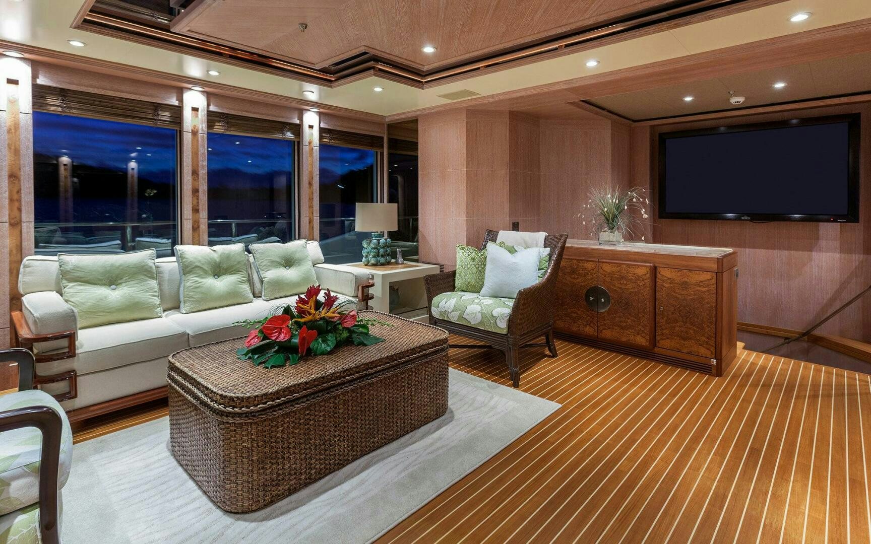 a living room with a couch and a tv aboard PERLE BLEUE Yacht for Sale
