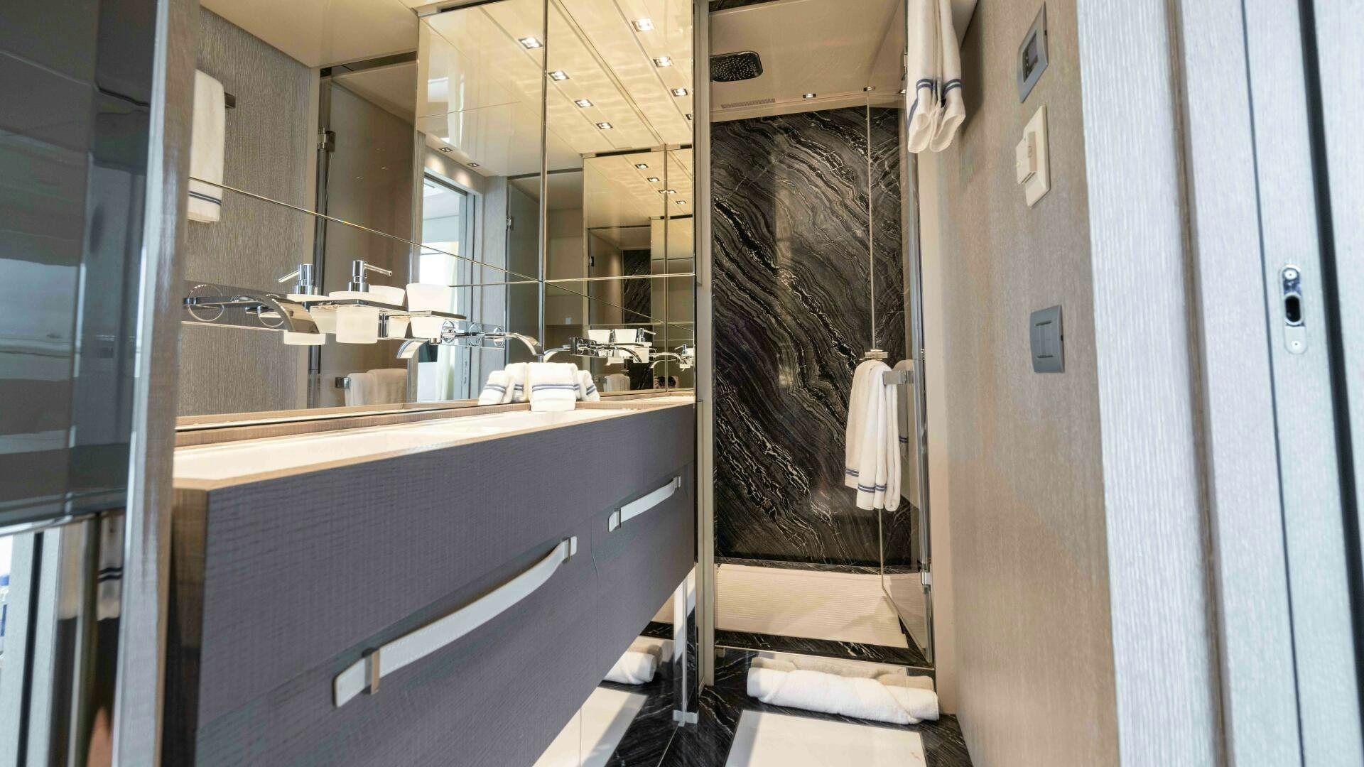 a bathroom with a sink and a mirror aboard HONEY POT Yacht for Sale