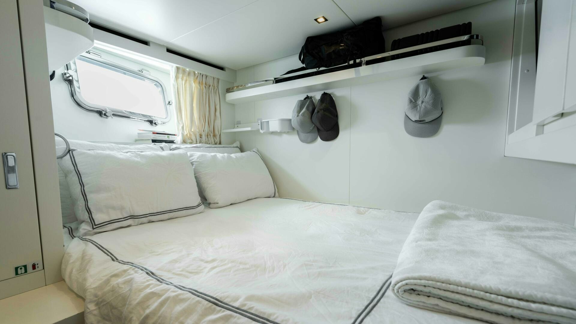 a bed with white sheets aboard HONEY POT Yacht for Sale