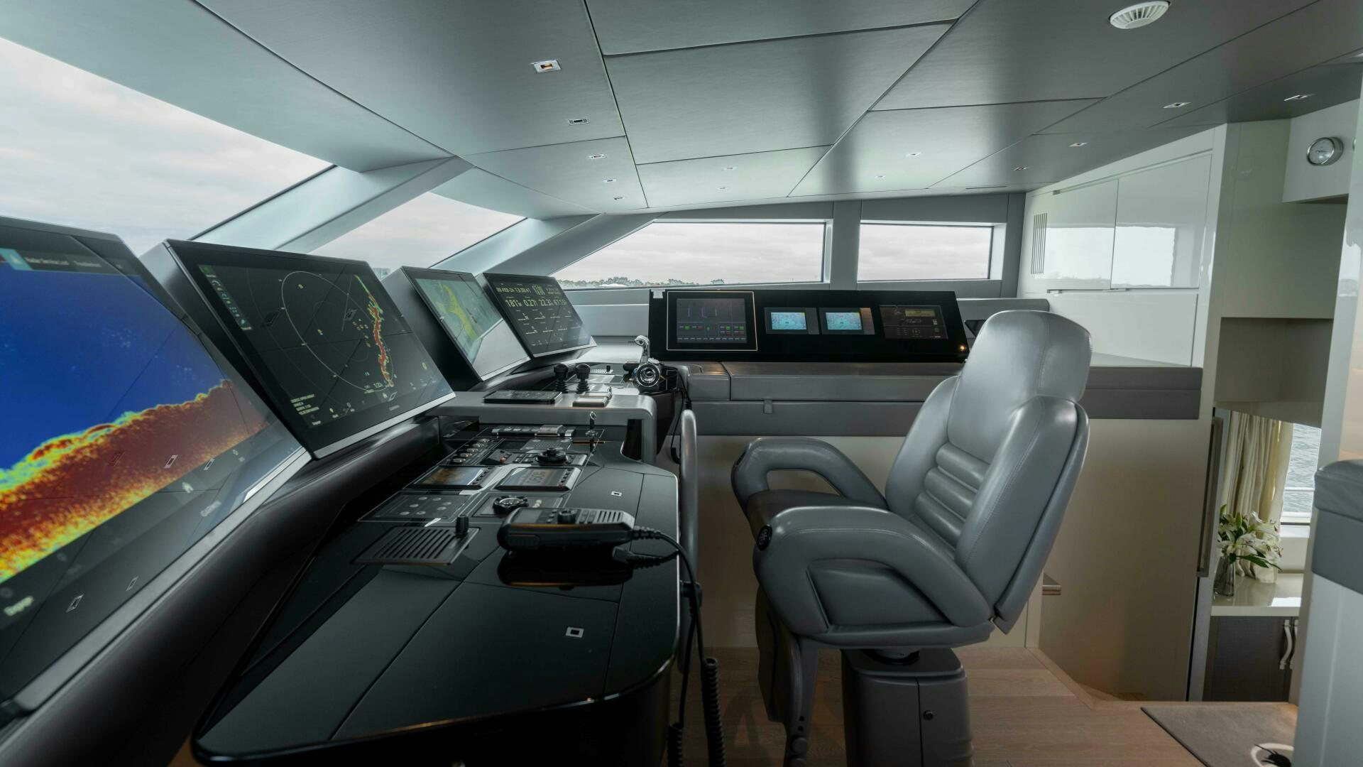 inside of a vehicle with a desk and chairs aboard HONEY POT Yacht for Sale