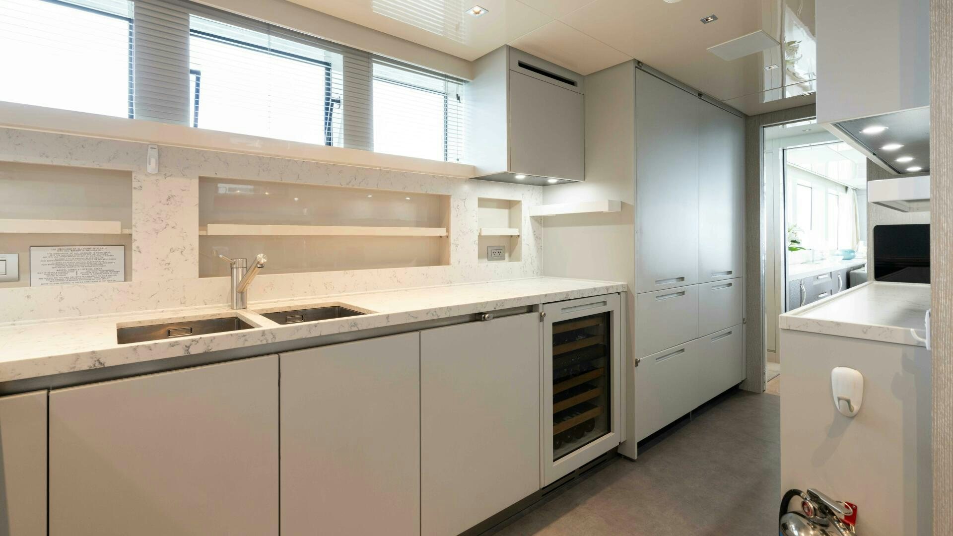 a kitchen with white cabinets aboard HONEY POT Yacht for Sale