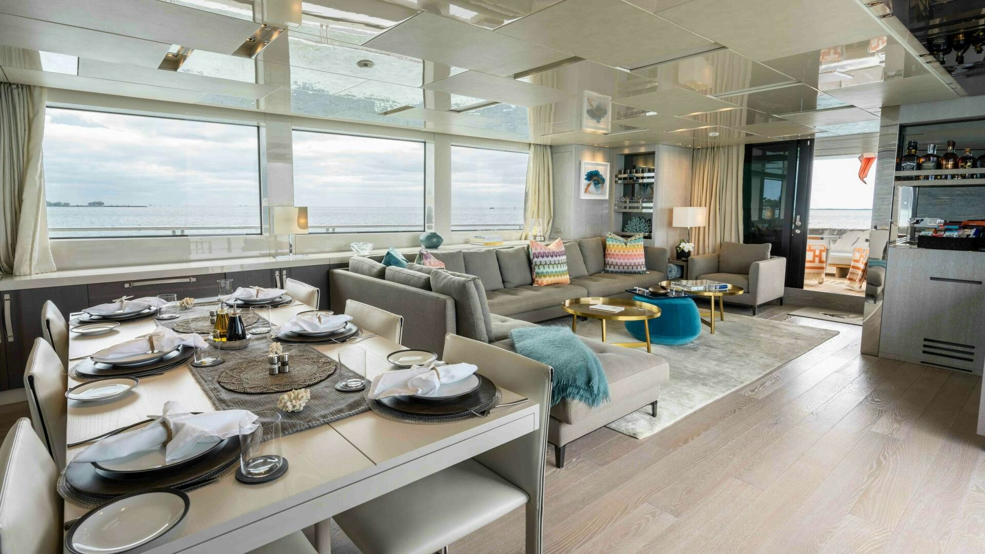 a large living room with a large table and chairs aboard HONEY POT Yacht for Sale