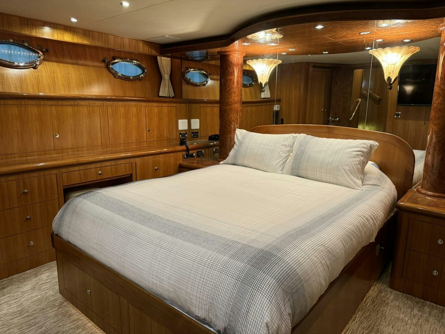a bed with a wooden wall aboard ALL ABORDEAUX Yacht for Sale