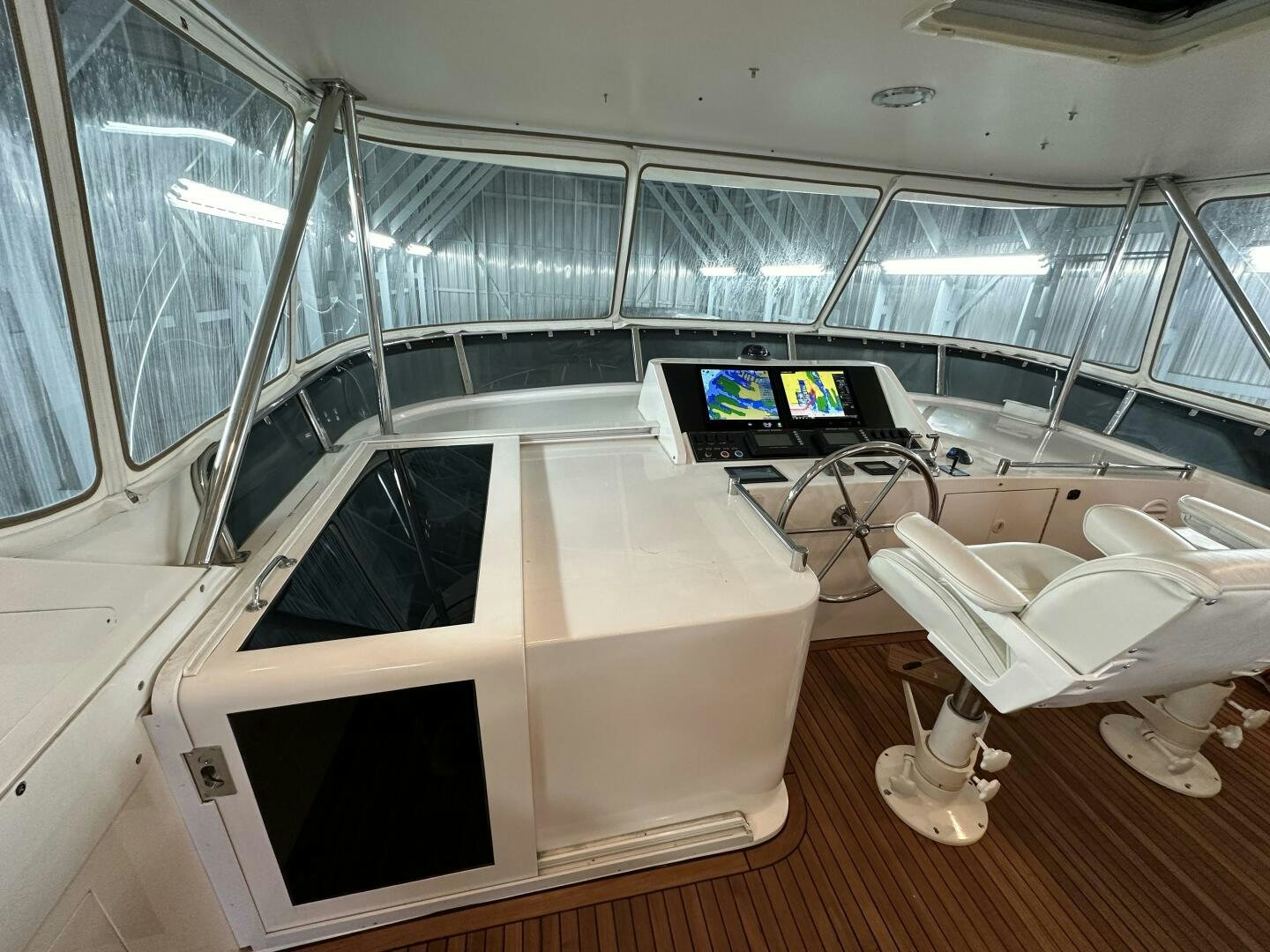 a room with a large window and a couple of computers on the side aboard ALL ABORDEAUX Yacht for Sale