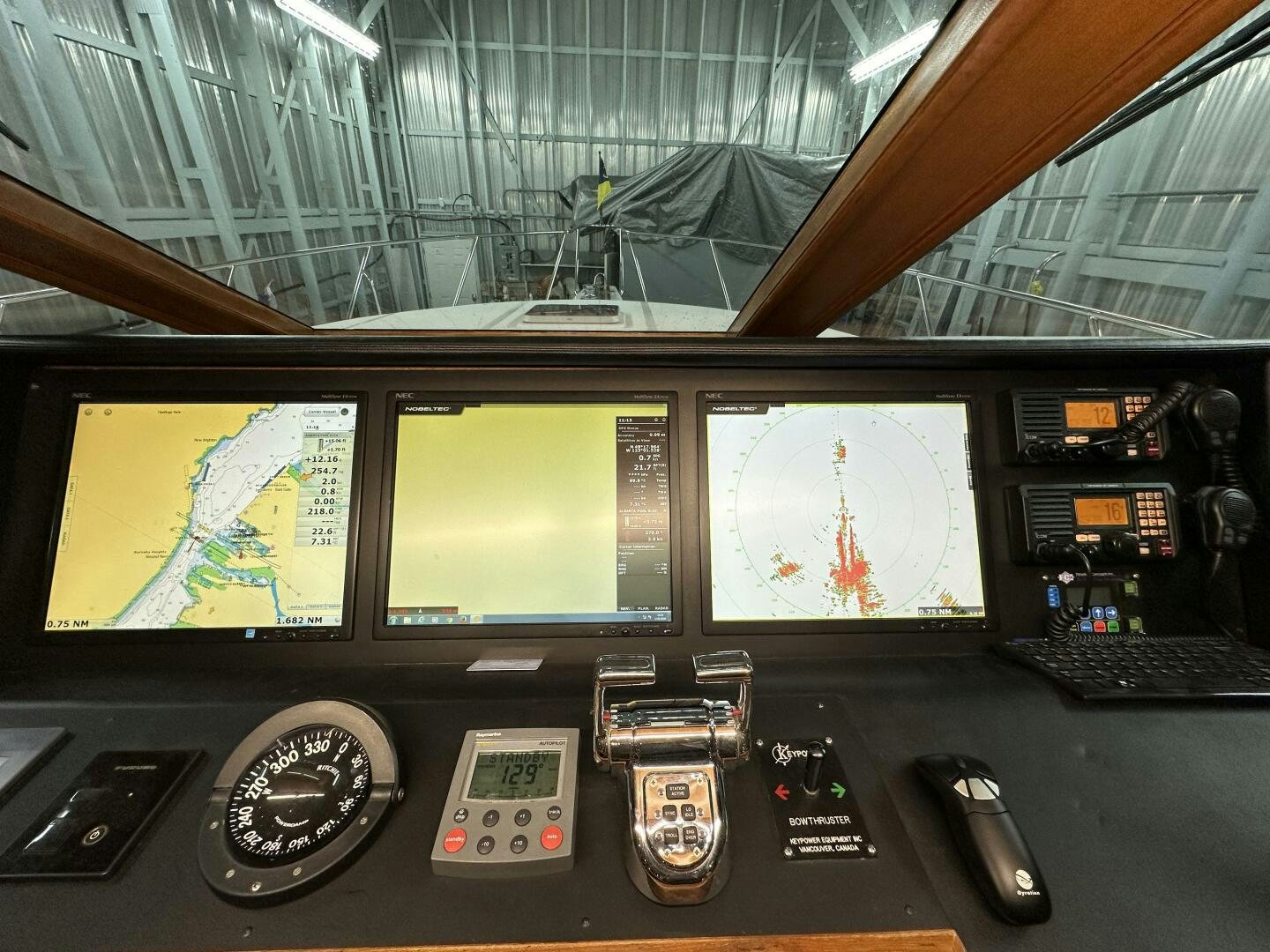 a desk with a computer and other electronic devices aboard ALL ABORDEAUX Yacht for Sale