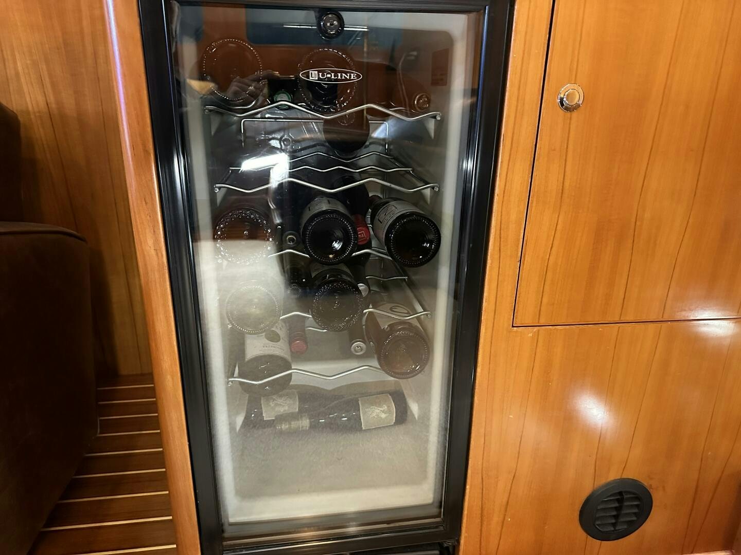 a glass case with a door open aboard ALL ABORDEAUX Yacht for Sale
