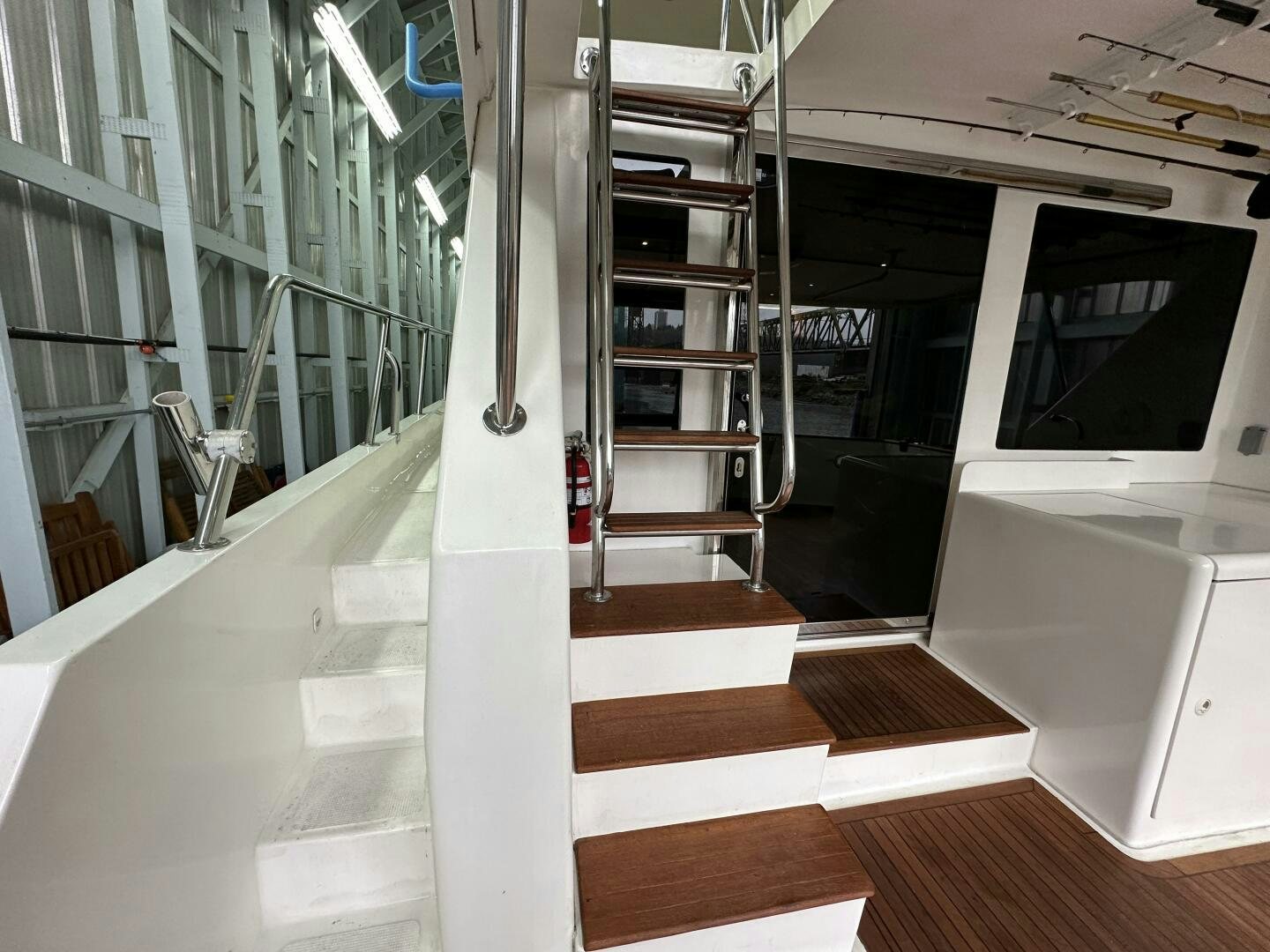 a room with glass walls and a wood floor and a staircase aboard ALL ABORDEAUX Yacht for Sale