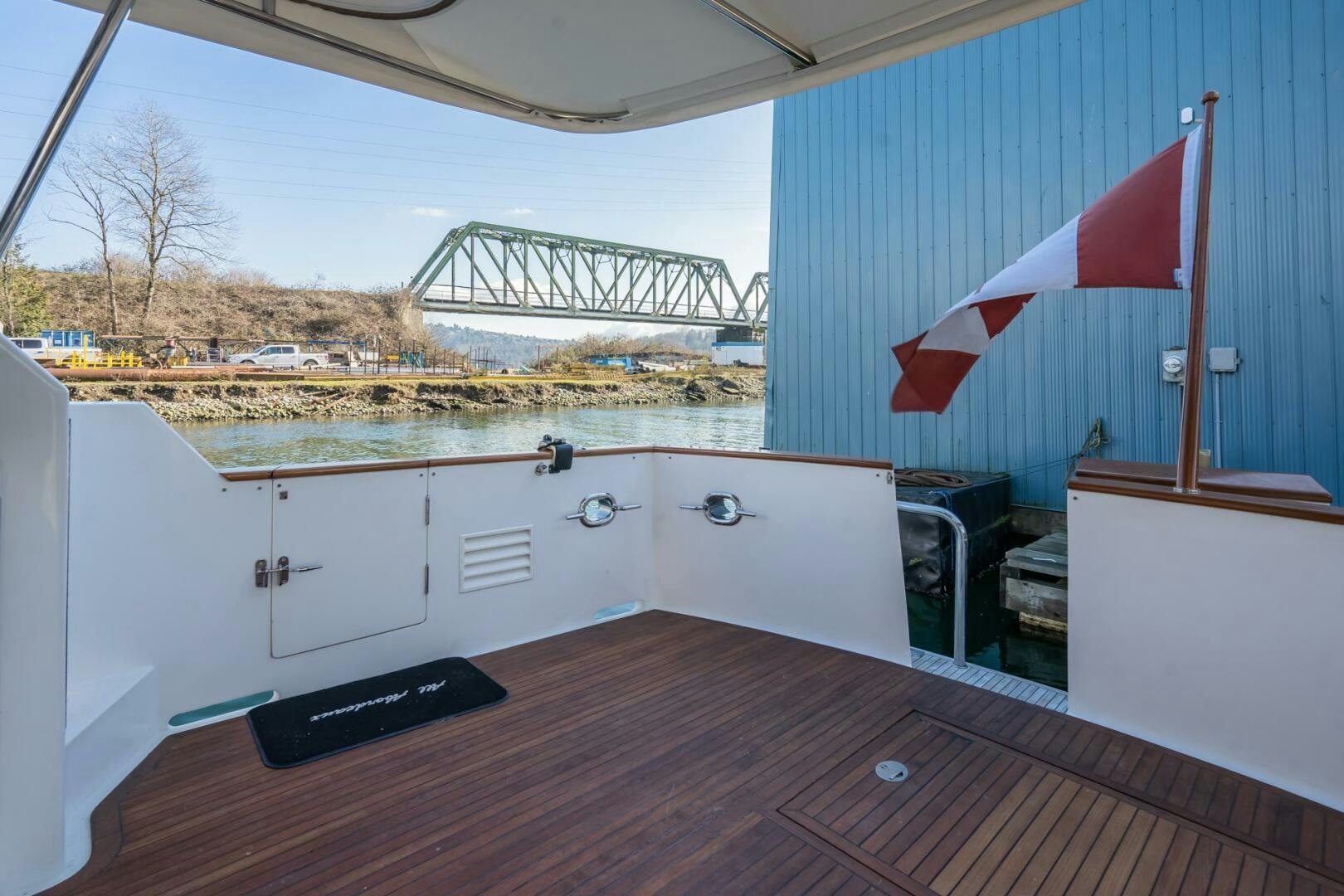 a deck with a view of a river and a bridge aboard ALL ABORDEAUX Yacht for Sale