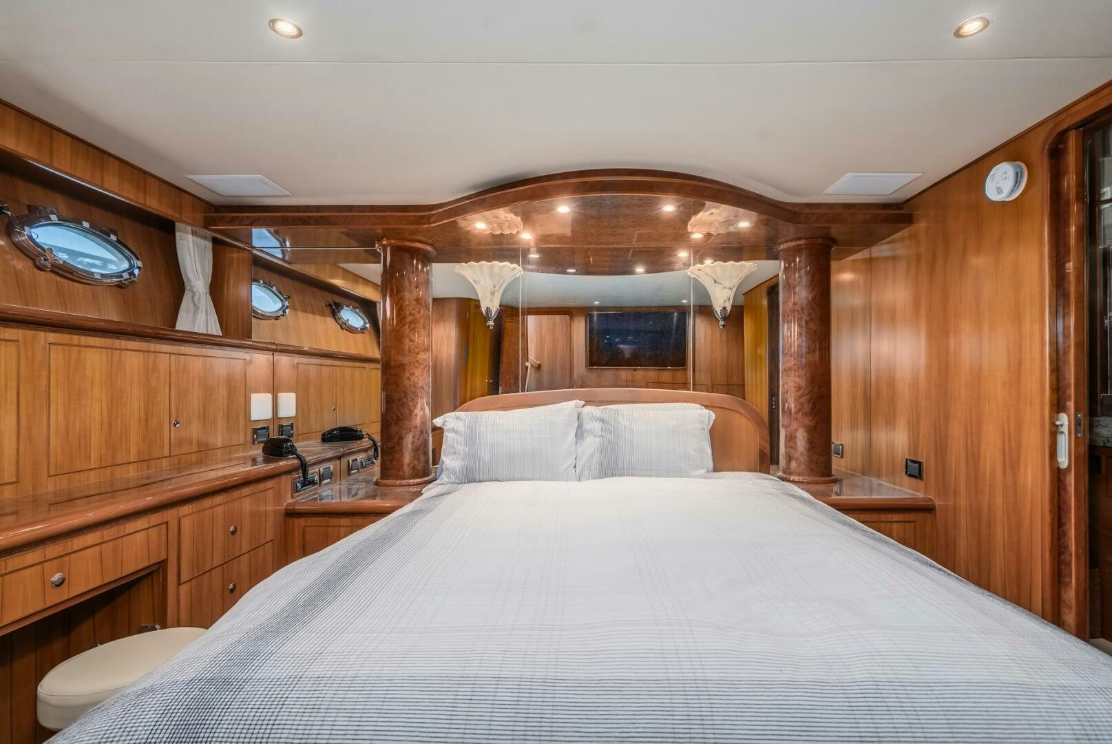 a bed with a wooden headboard aboard ALL ABORDEAUX Yacht for Sale