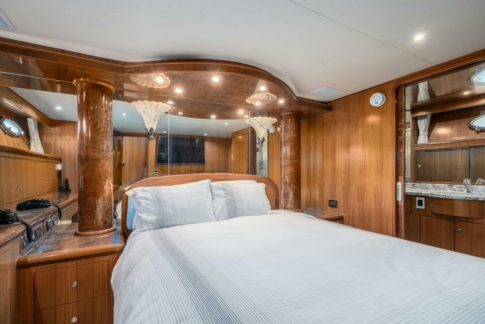 a bedroom with a wood wall aboard ALL ABORDEAUX Yacht for Sale
