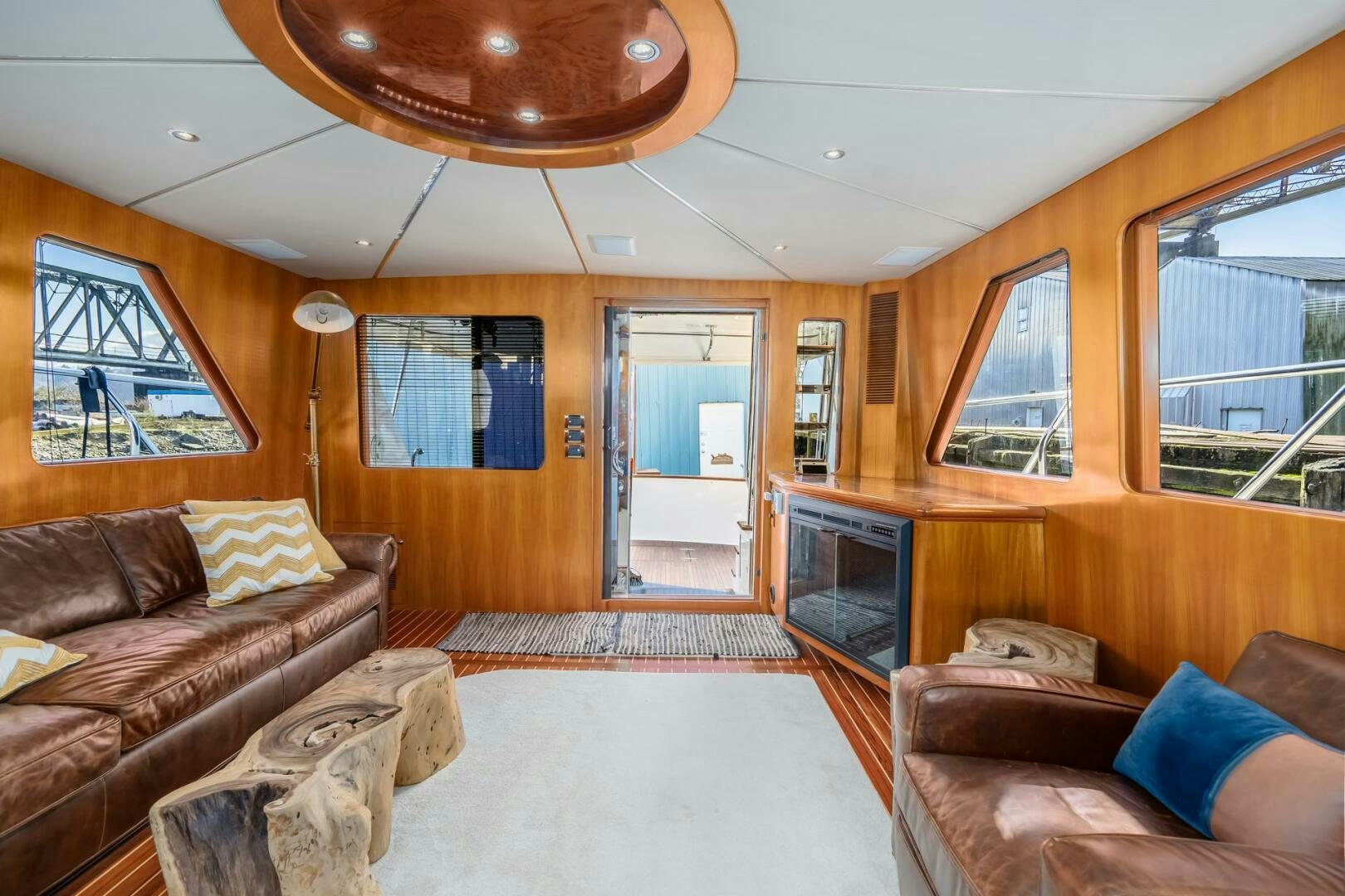 a living room with a fireplace aboard ALL ABORDEAUX Yacht for Sale