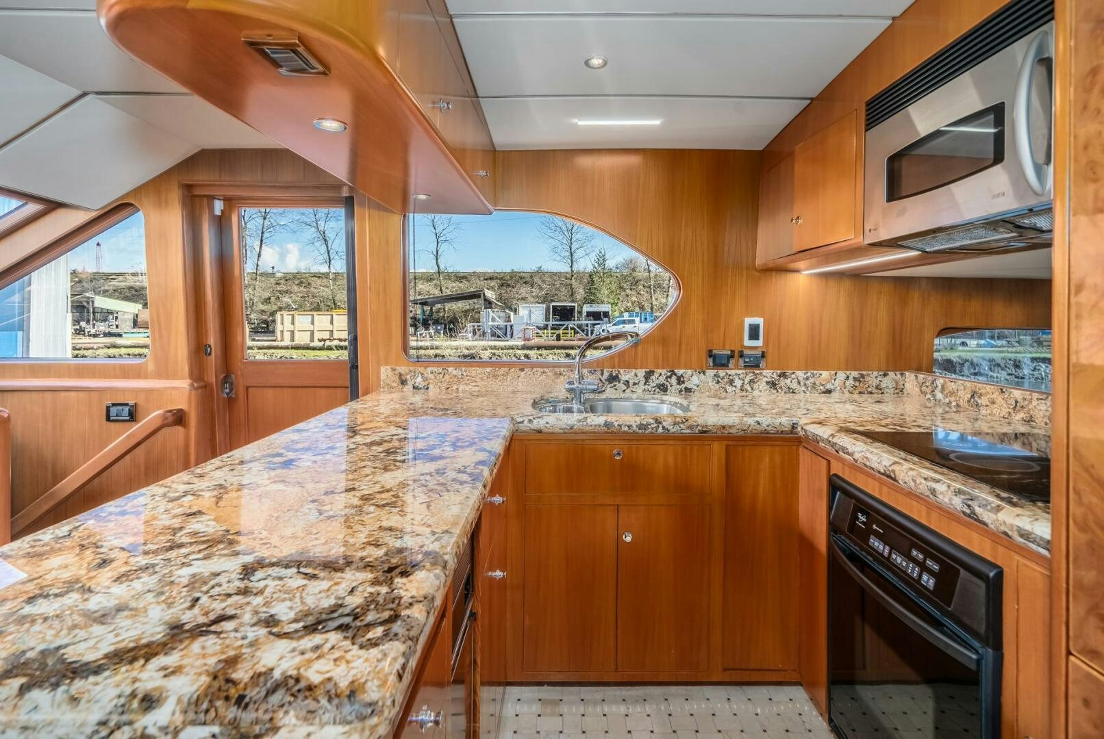 a kitchen with wooden cabinets aboard ALL ABORDEAUX Yacht for Sale