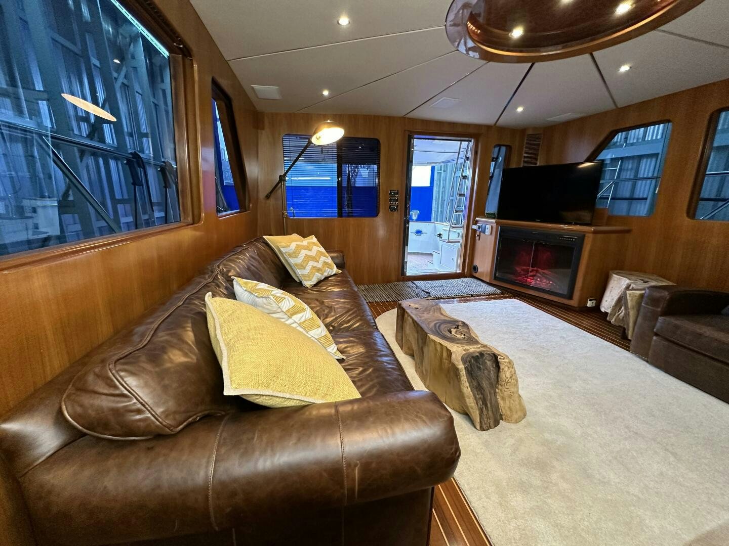 a living room with a leather couch aboard ALL ABORDEAUX Yacht for Sale