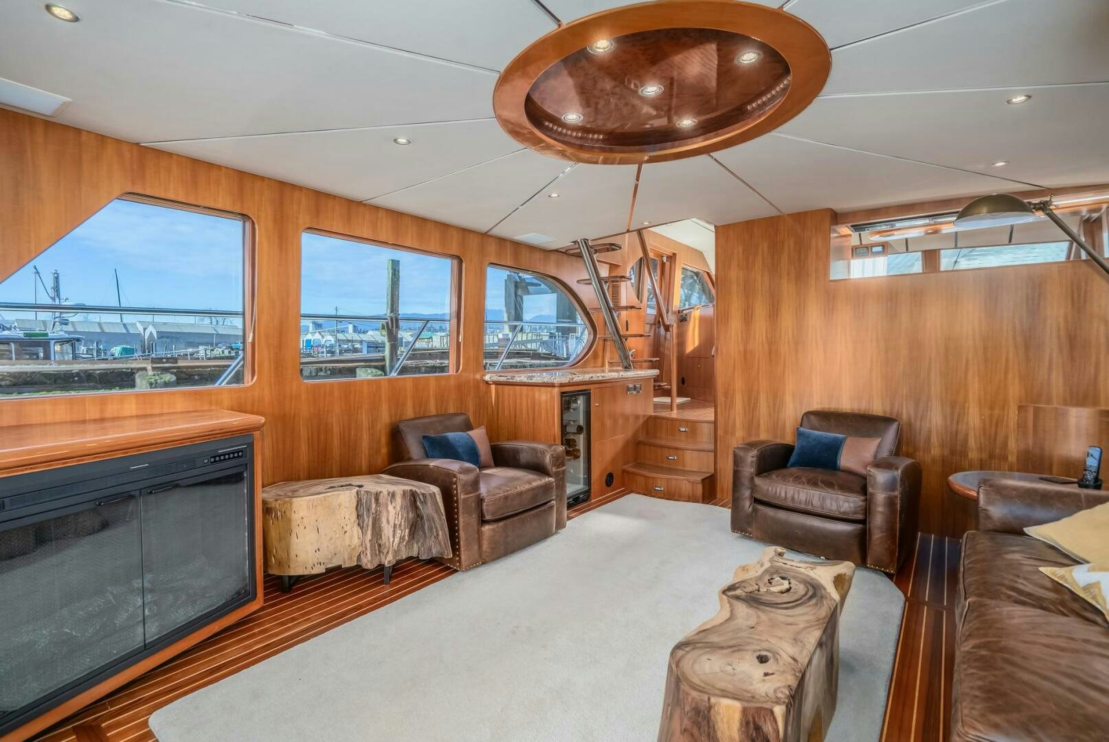 a living room with a fireplace aboard ALL ABORDEAUX Yacht for Sale