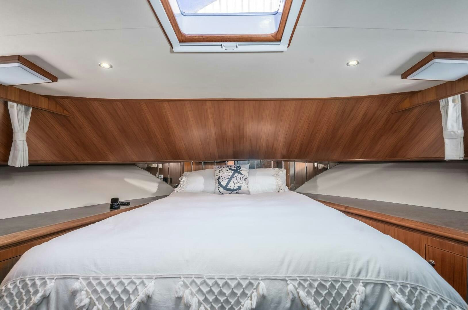 a bed with a wooden headboard aboard ALL ABORDEAUX Yacht for Sale